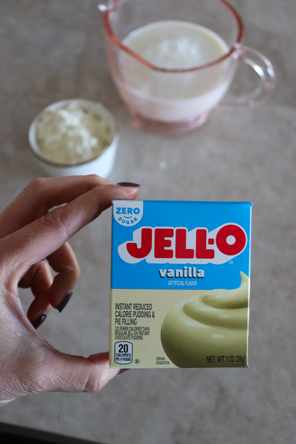 Jell-o pudding pack with a bowl of protein powder and milk.