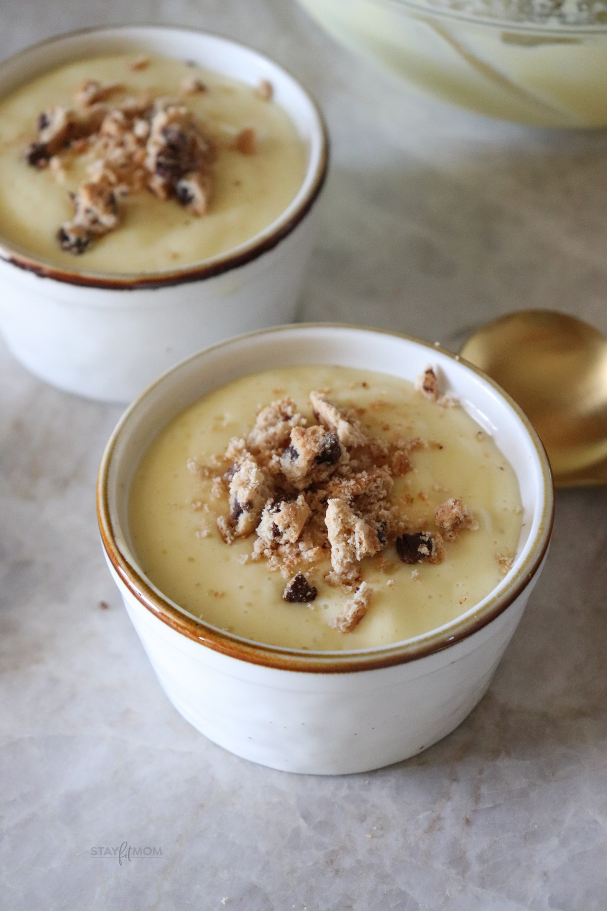 vanilla pudding ina small cup with crushed cookies on top