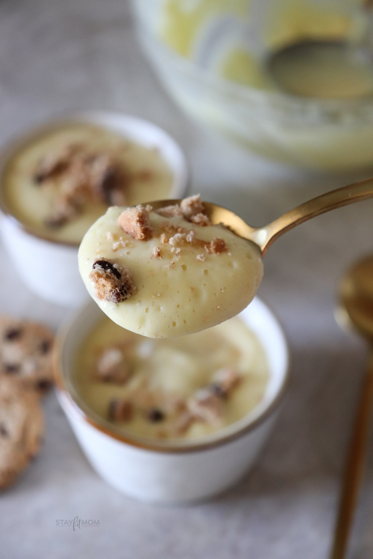spoonfull of protein pudding with crushed cookies on top.