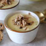 vanilla pudding ina small cup with crushed cookies on top