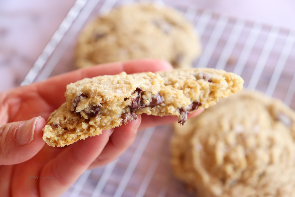 spilt open oatmeal chocolate chip cookie. A gooey inside with melted chocolate chips visible.