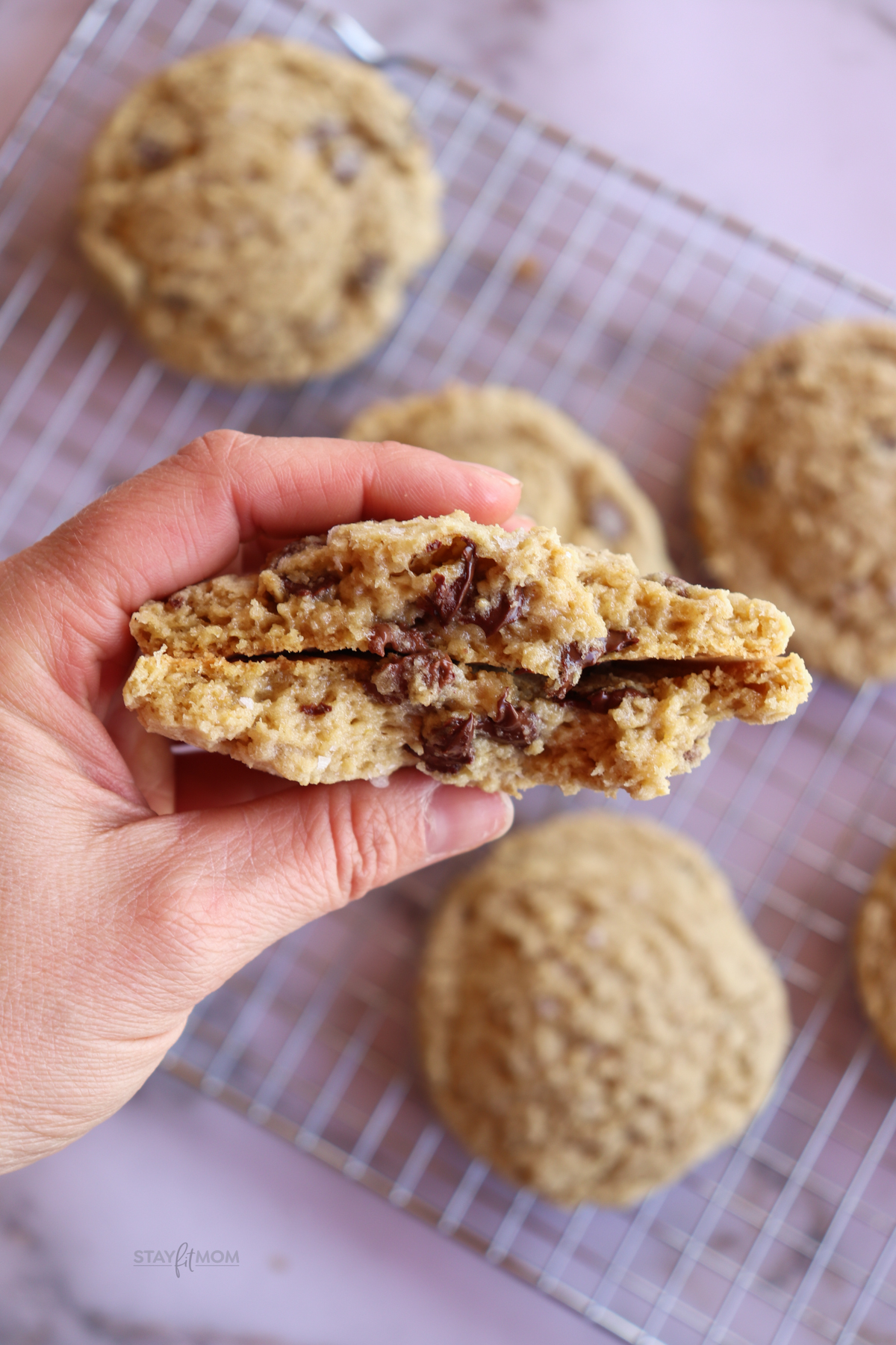 oatmeal chocolate chip cookie split in half with melted chocolate and a gooey center.