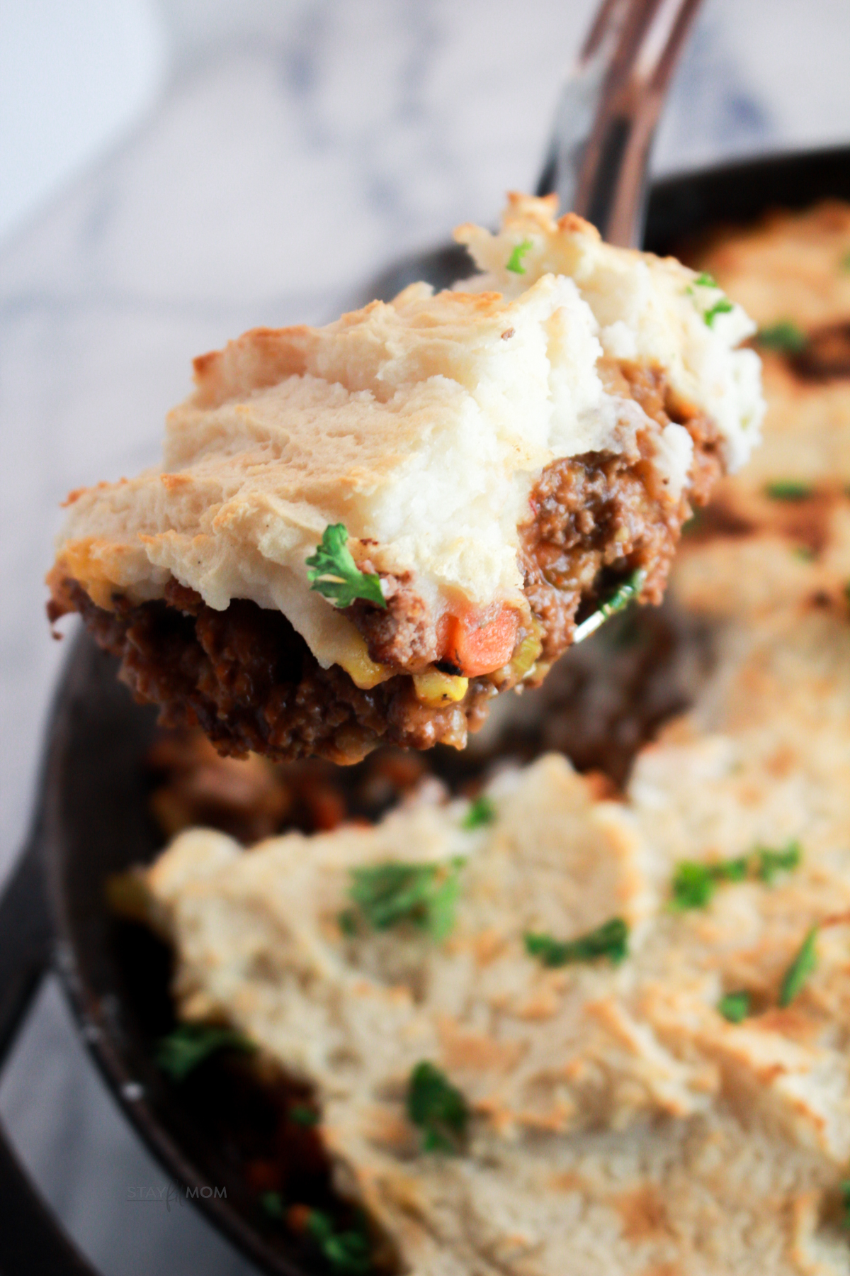 Macro-friendly Shepherd&rsquo;s Pie baked until golden brown with creamy mashed potato topping and hearty beef filling in a white casserole dish.
