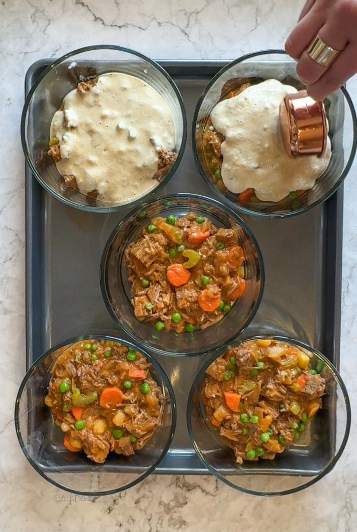 Shredded Beef Bowls showing 5 bowls with veggie mixture being topped with pancake batter topping.