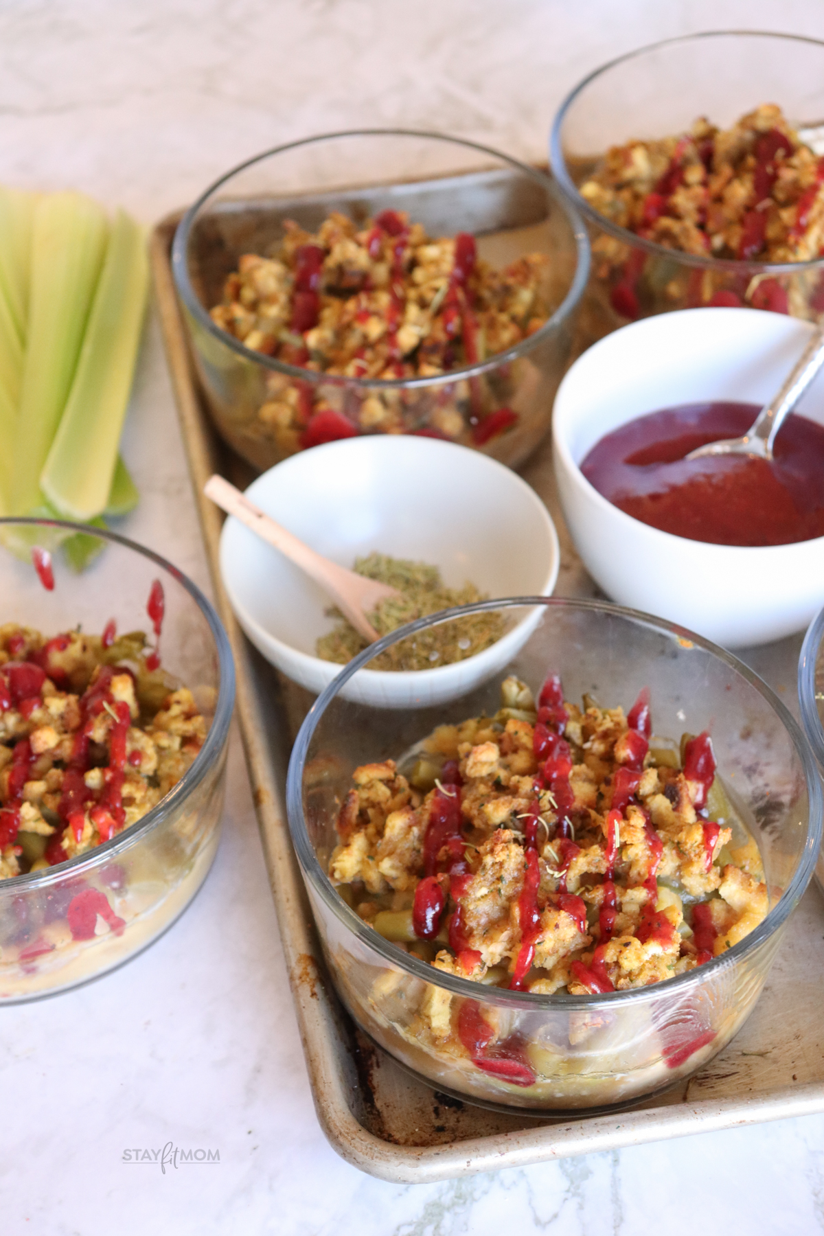 Thanksgiving bowls loaded with turkey, green beans, stuffing, gravy, and topped with a cranberry sauce drizzle.