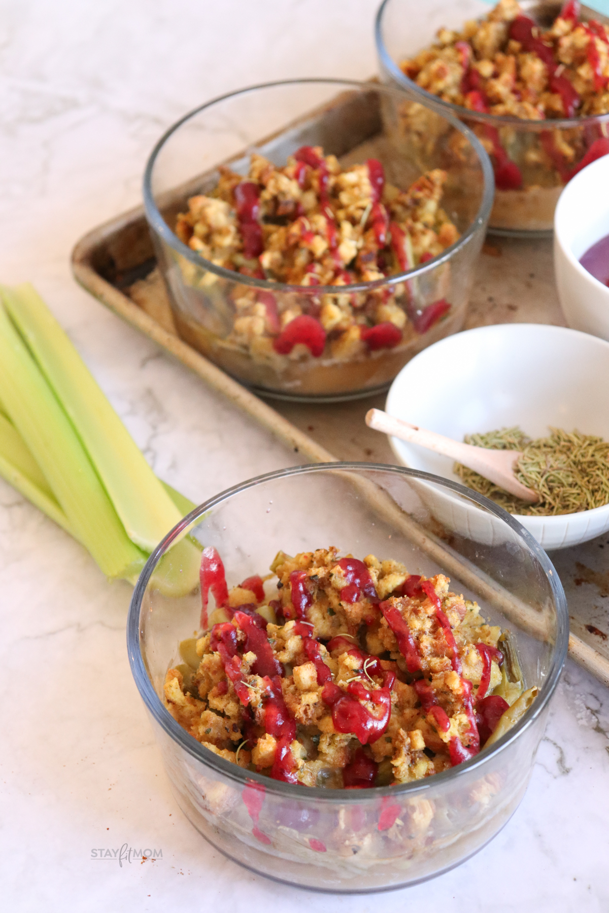 Thanksgiving bowls loaded with turkey, green beans, stuffing, gravy, and topped with a cranberry sauce drizzle.