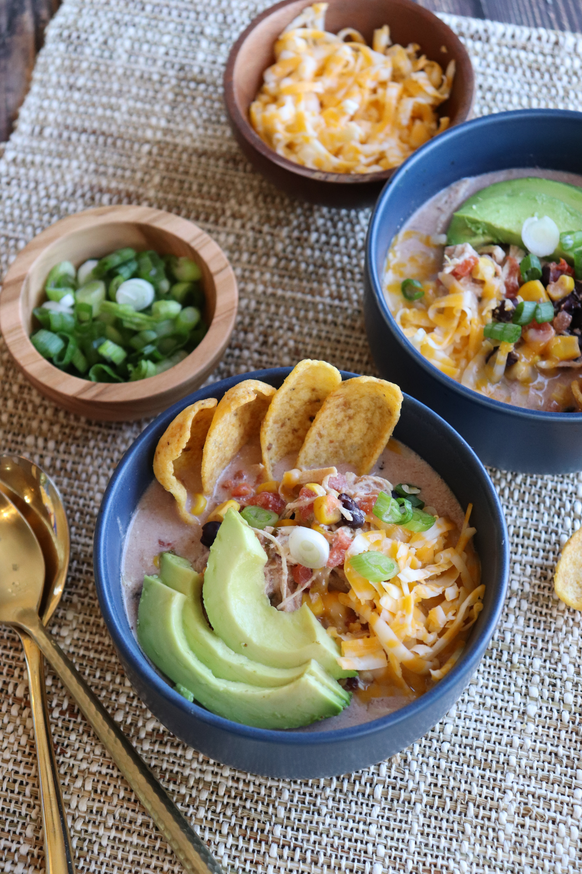 Stay Fit Mom Cream Cheese Chicken Chili topped with avocado, cheese, and green onions. #chickenchili