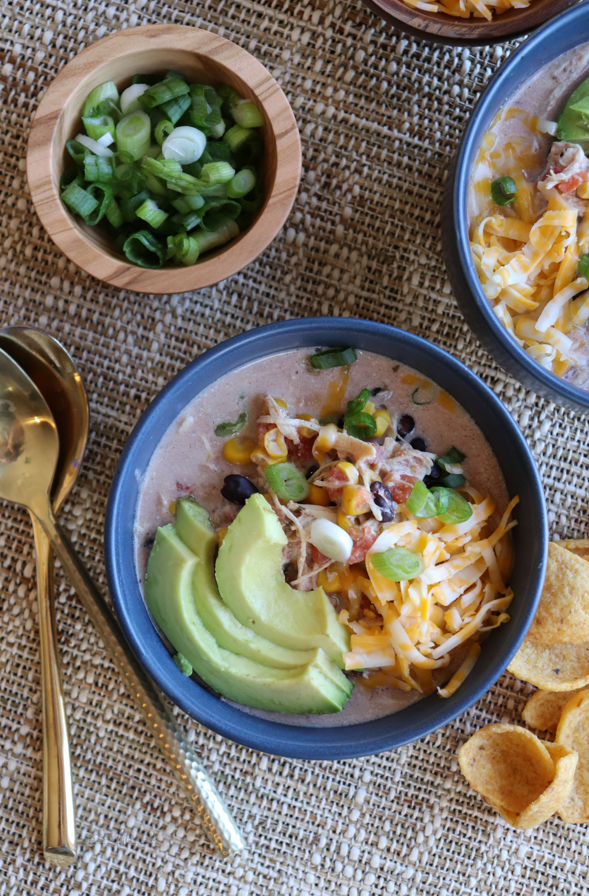 Stay Fit Mom Cream Cheese Chicken Chili topped with avocado, cheese, and green onions. #chickenchili
