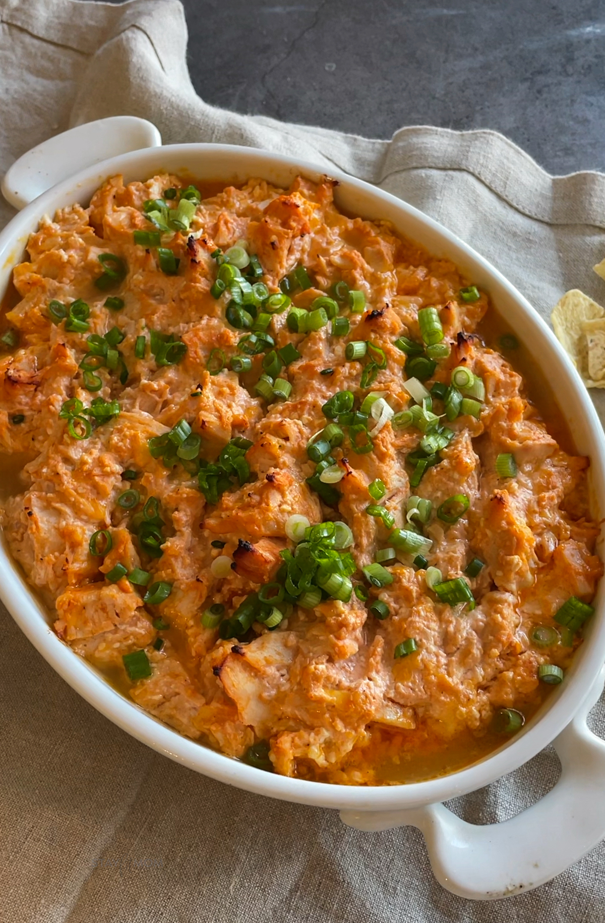 Buffalo Chicken Dip showing completed dip topped with green onions.