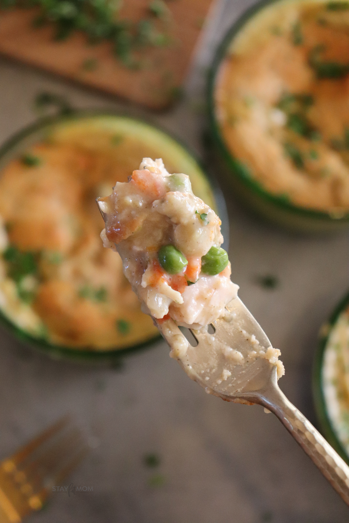 Chicken Pot Pie showing the perfect bite with chicken, veggies, crust, and a creamy sauce.