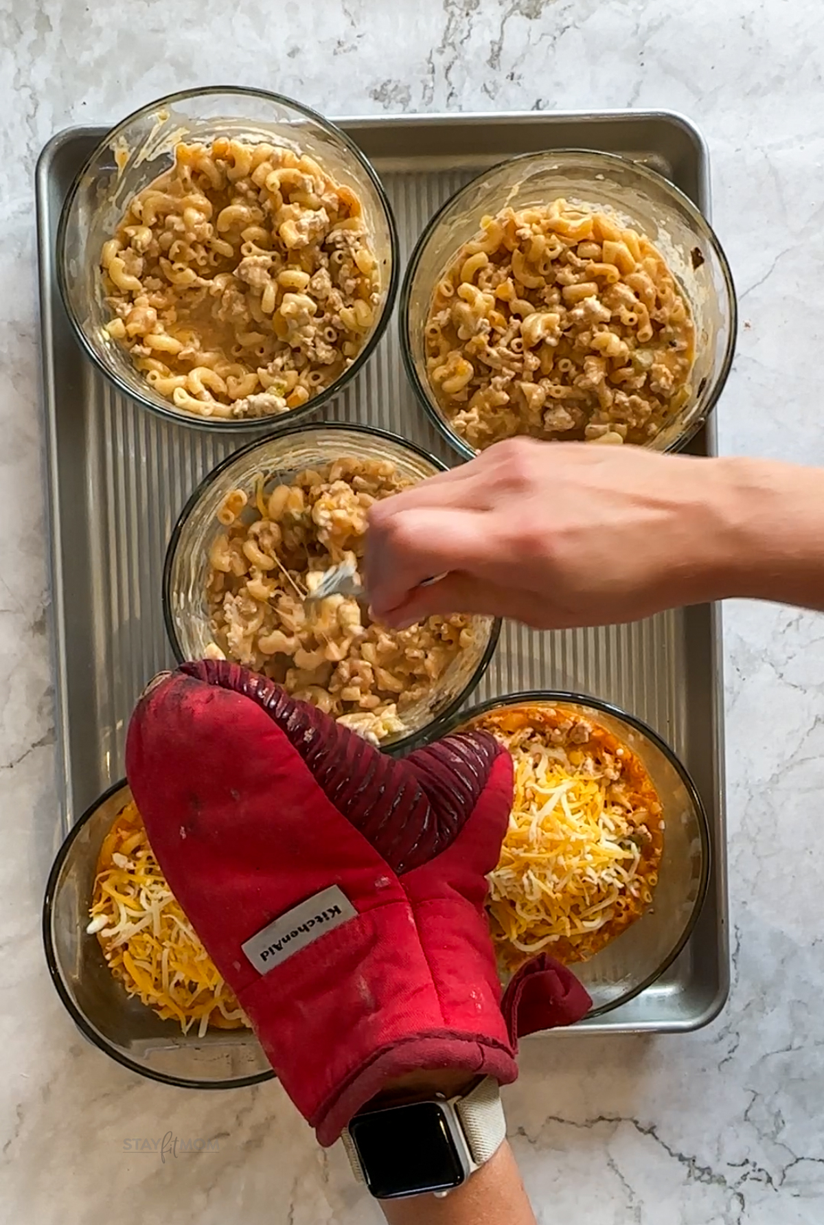Chili Mac & cheese bowls being stirred together after baking.