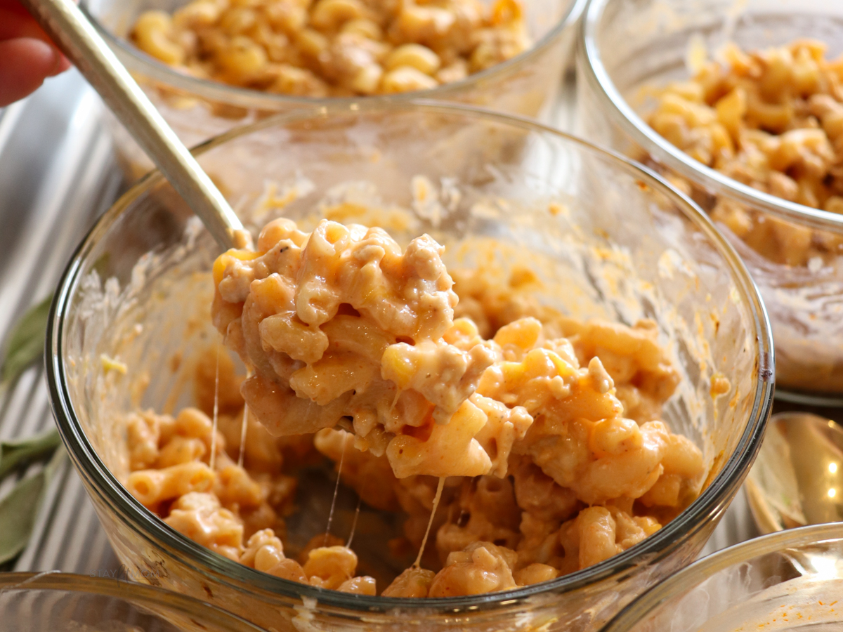 Close up image of a bite of chili mac & cheese.