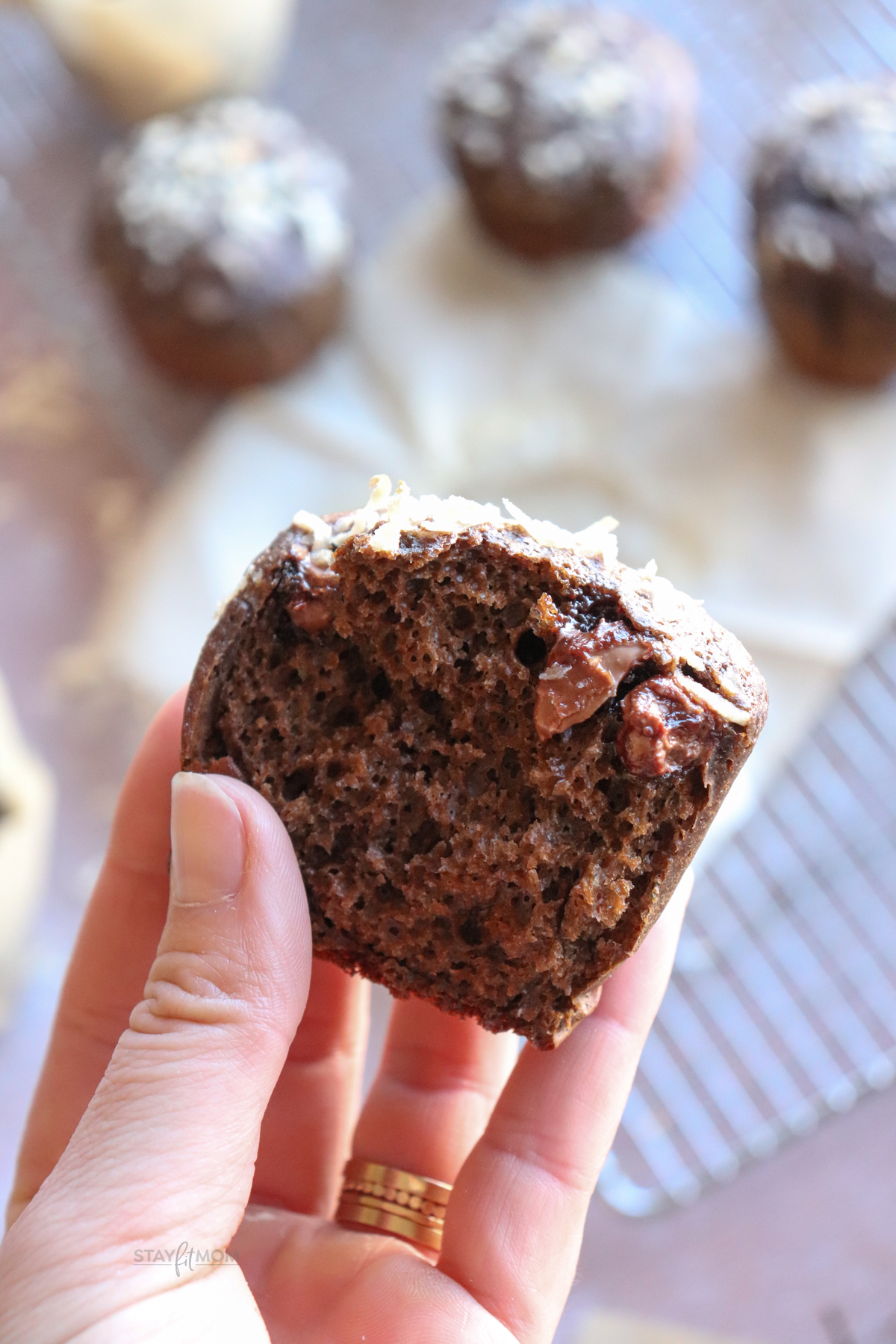 German Chocolate Protein Muffins showing a muffin in half to show texture.