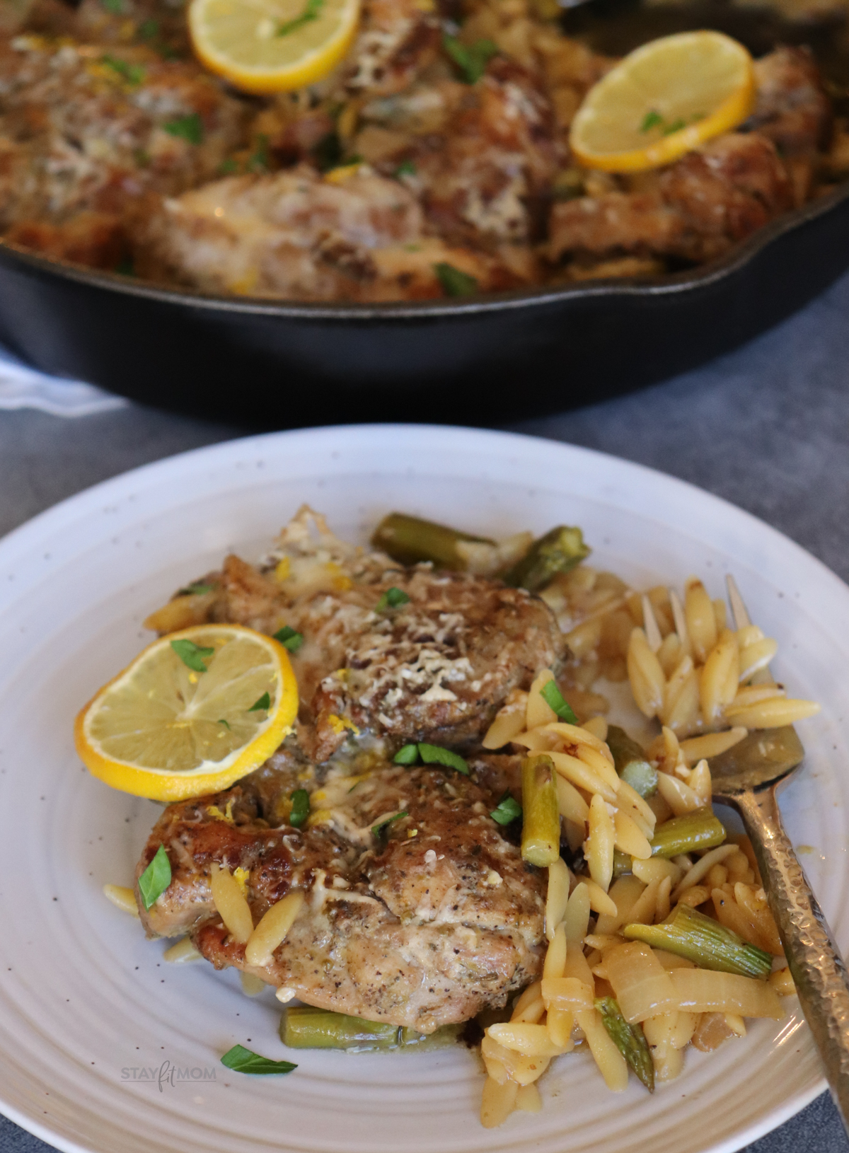 One Dish Lemon Chicken Orzo showing a serving on a plate.