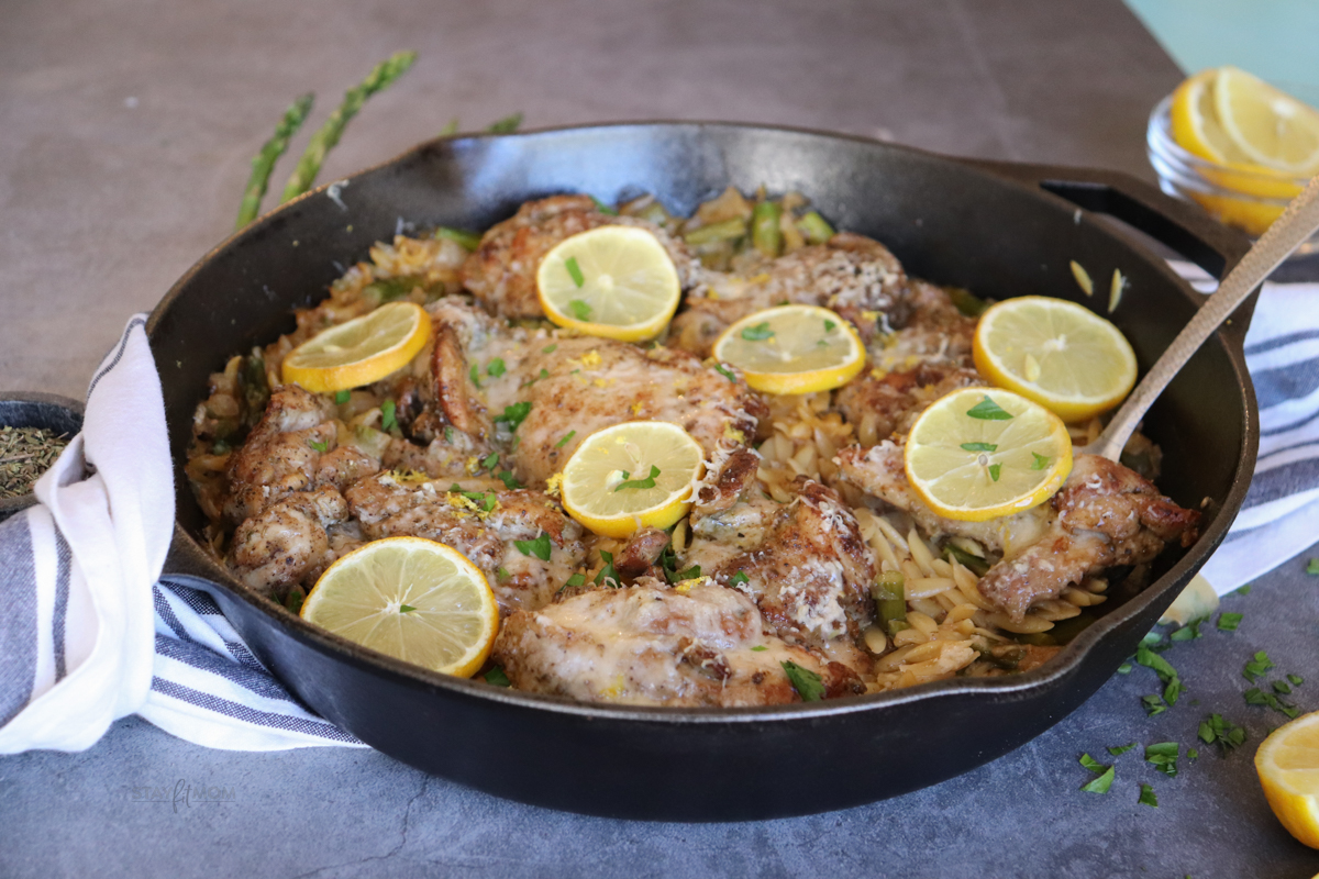 One dish lemon chicken orzo showing completed meal in cast iron skillet.
