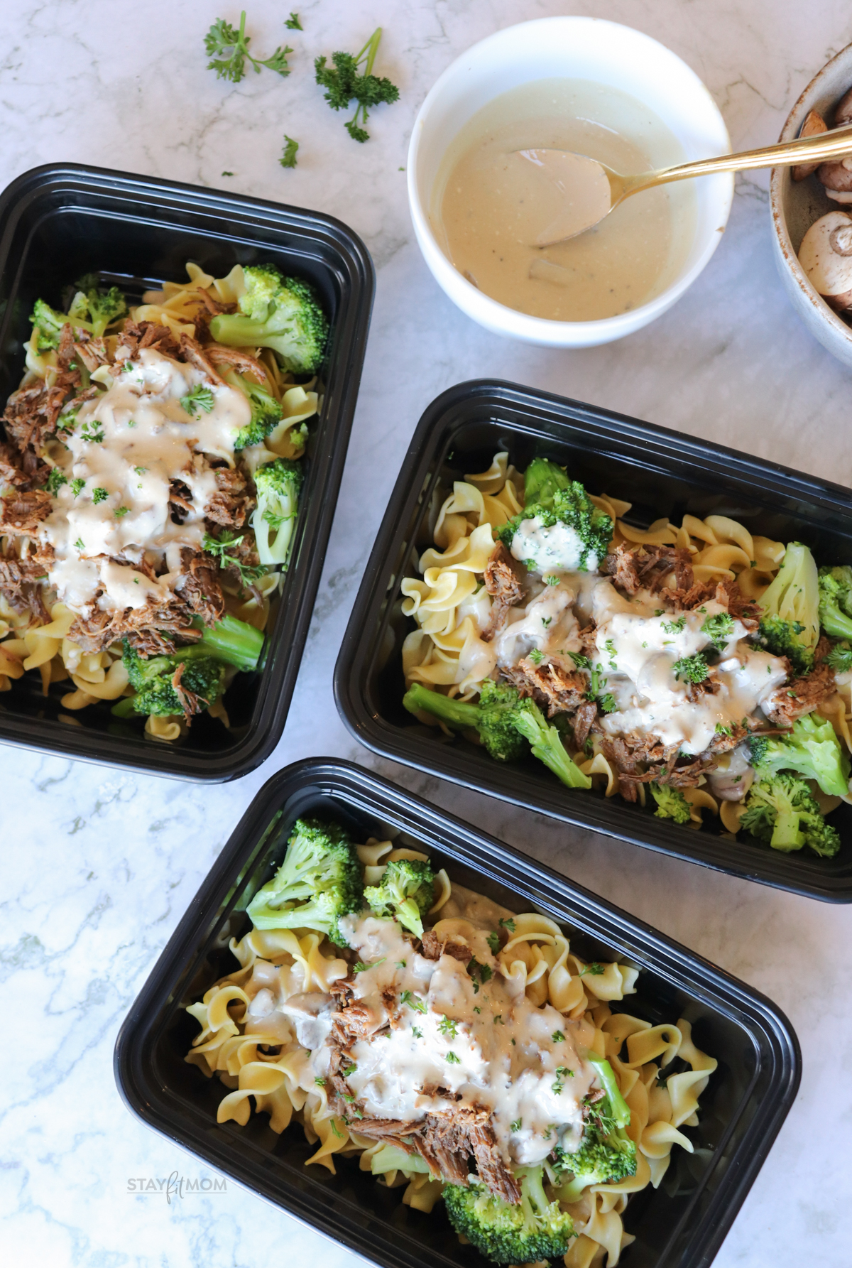 Beef Stroganoff Bowls showing completed meal with visible egg noodles, shredded beef, broccoli, and creamy sauce.
