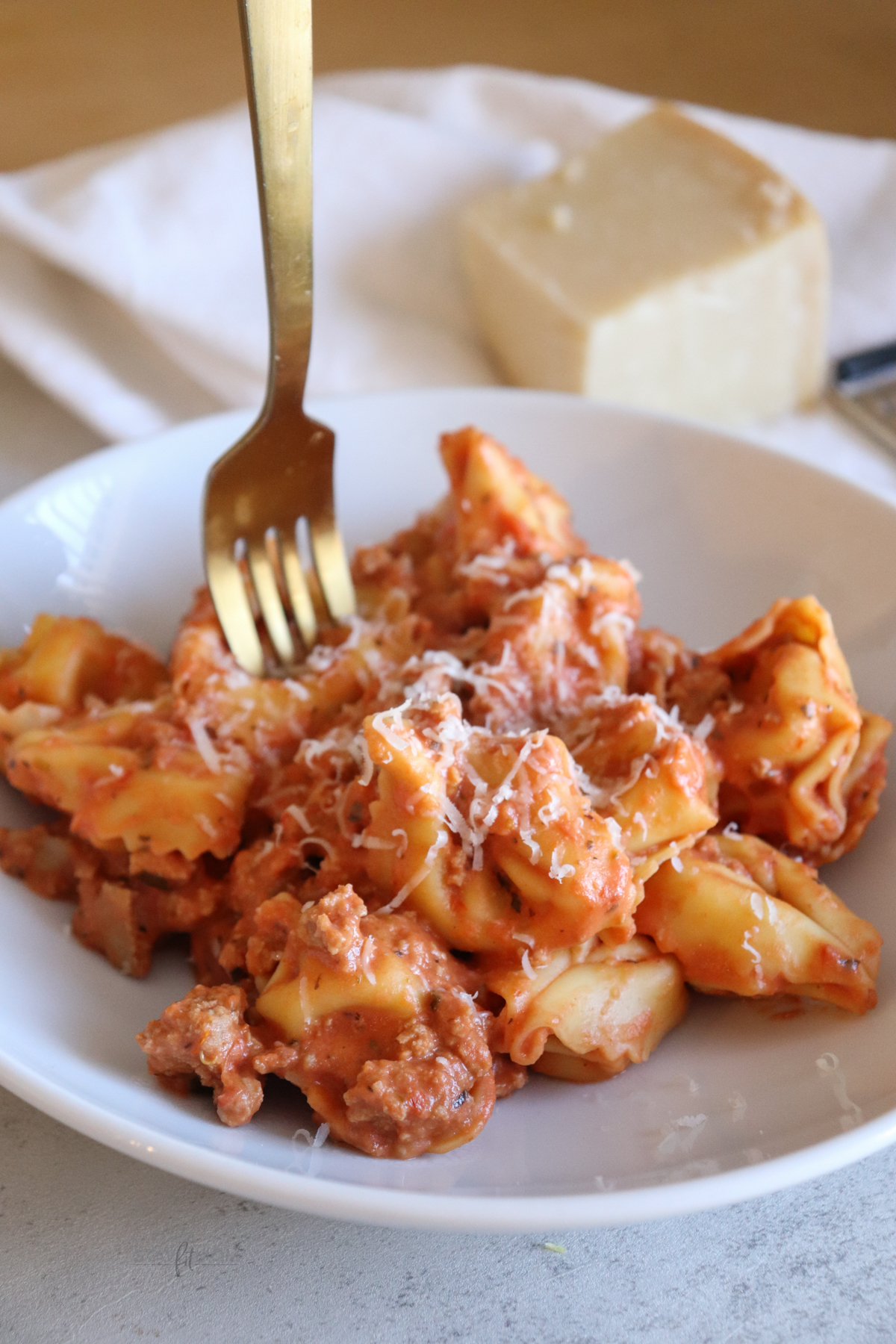 Chad's Easy Tortellini showing completed meal with visible tortellini, red sauce, and a sprinkle of cheese.