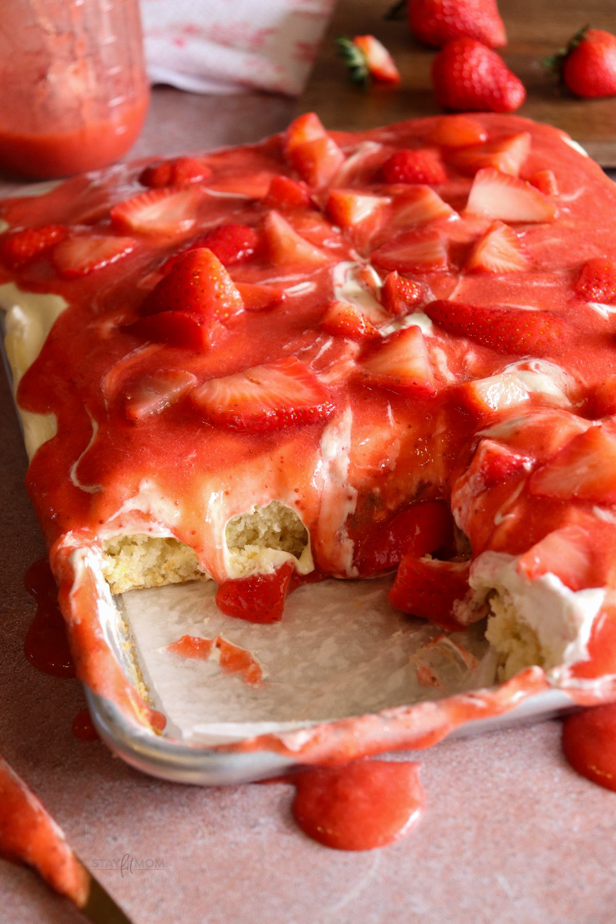Strawberry shortcake showing completed dessert with visible cake, cream topping, and strawberries.