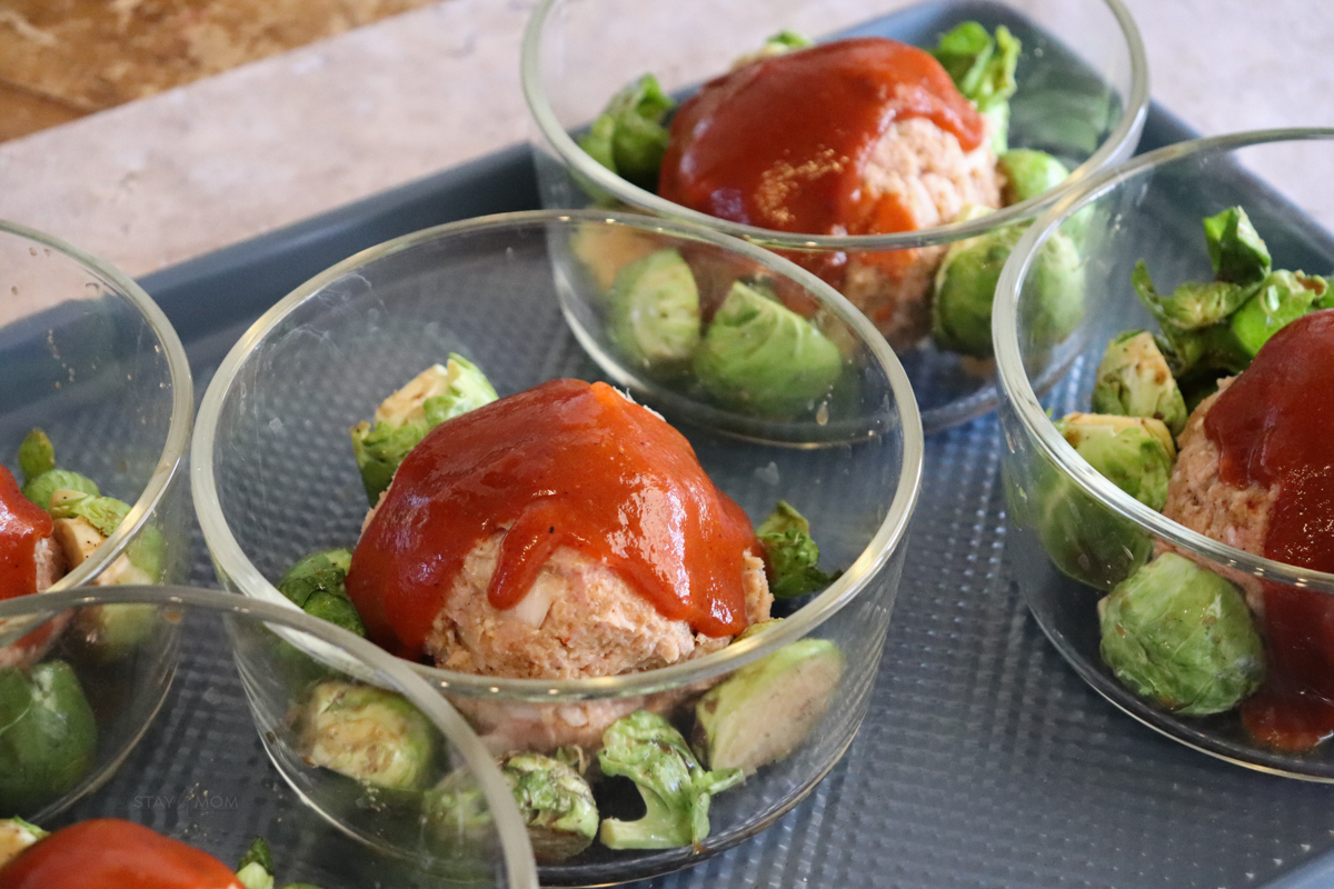 BBQ Turkey meatloaf bowls with meatball and Brussels sprouts topped with BBQ sauce.