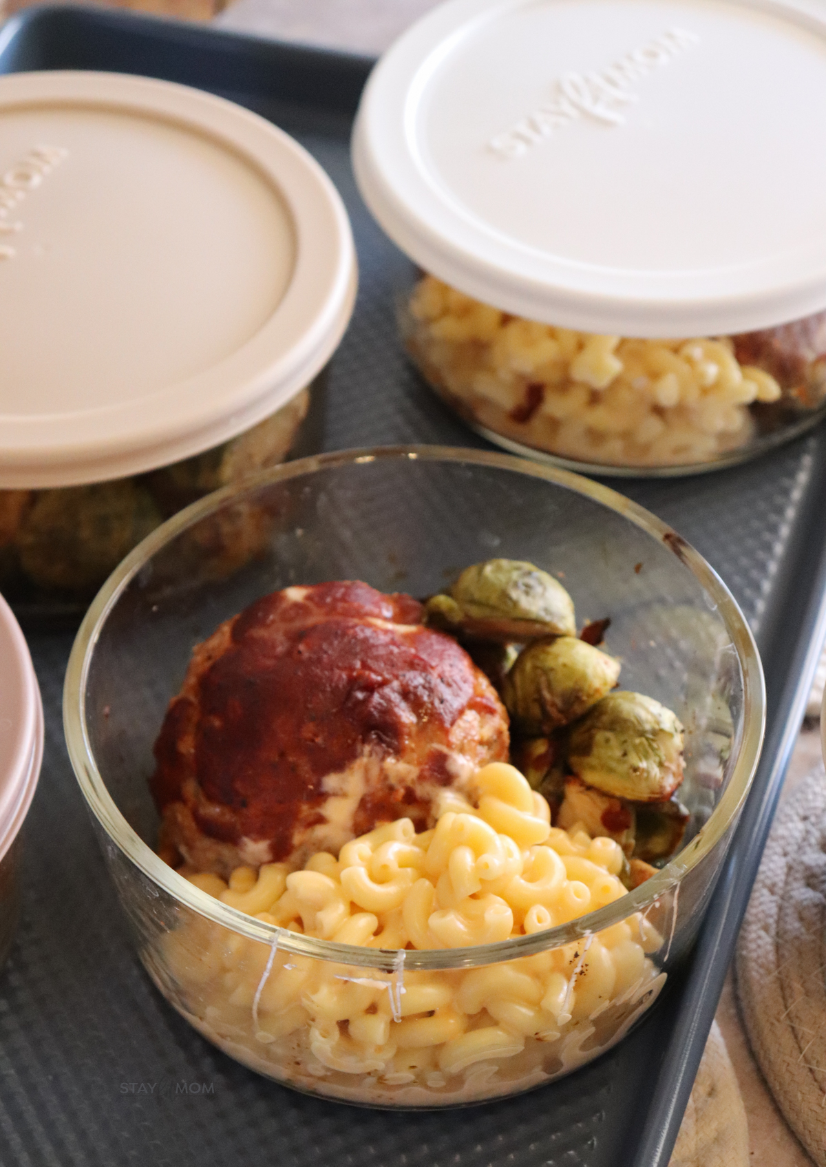 BBQ turkey meatloaf bowls with completed meal showing bbq meatball, Brussels sprouts, and mac & cheese.