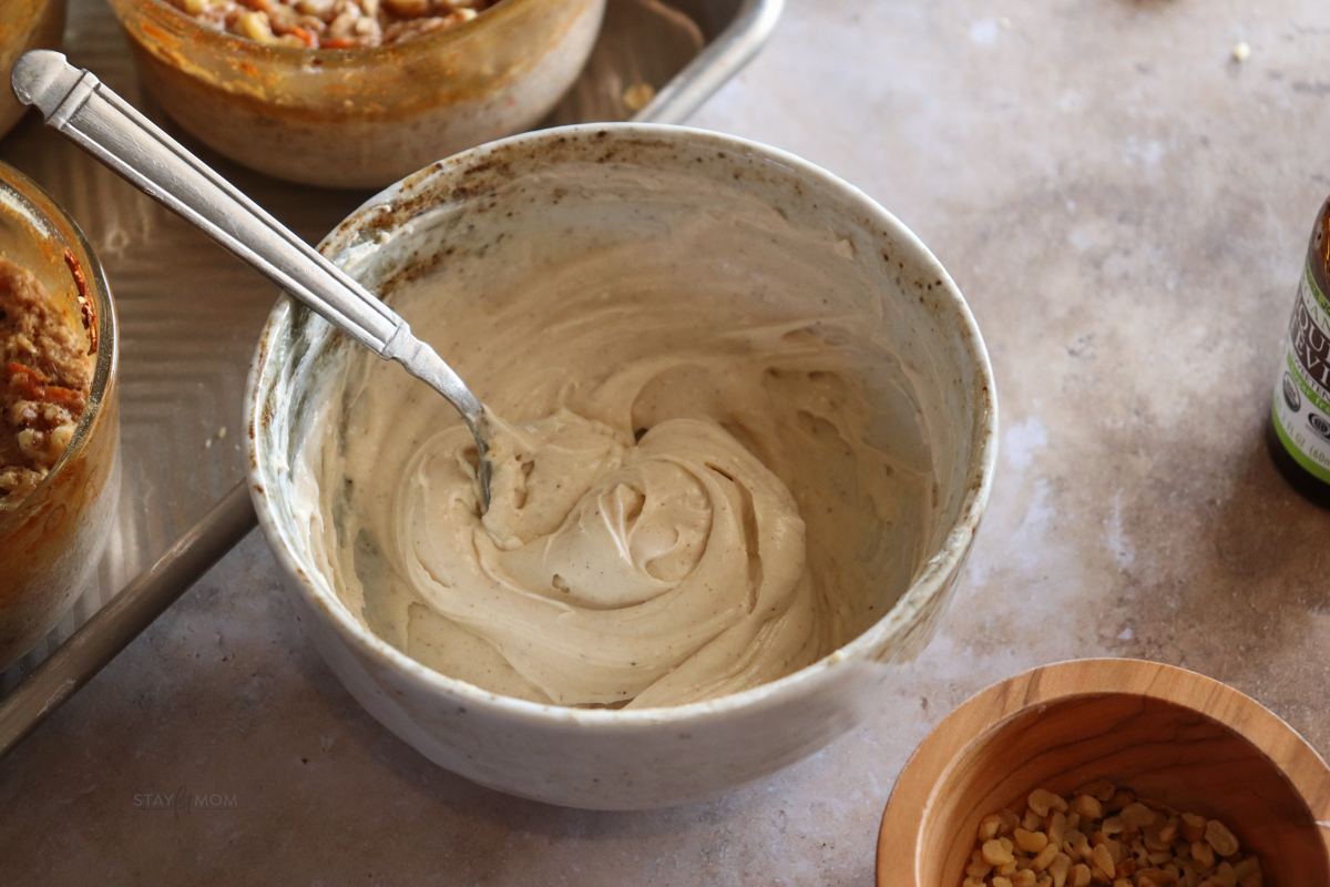 Carrot cake baked oats showing bowl of protein frosting.