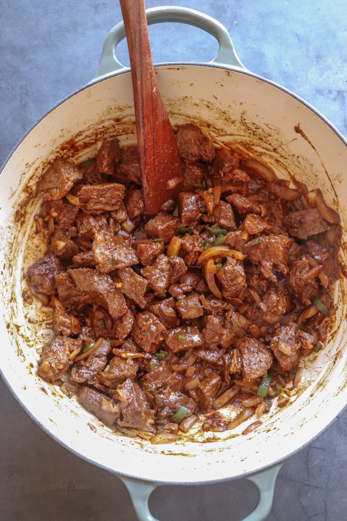 Texas chili showing chuck roast cooked with onions, jalapenos, and spices.