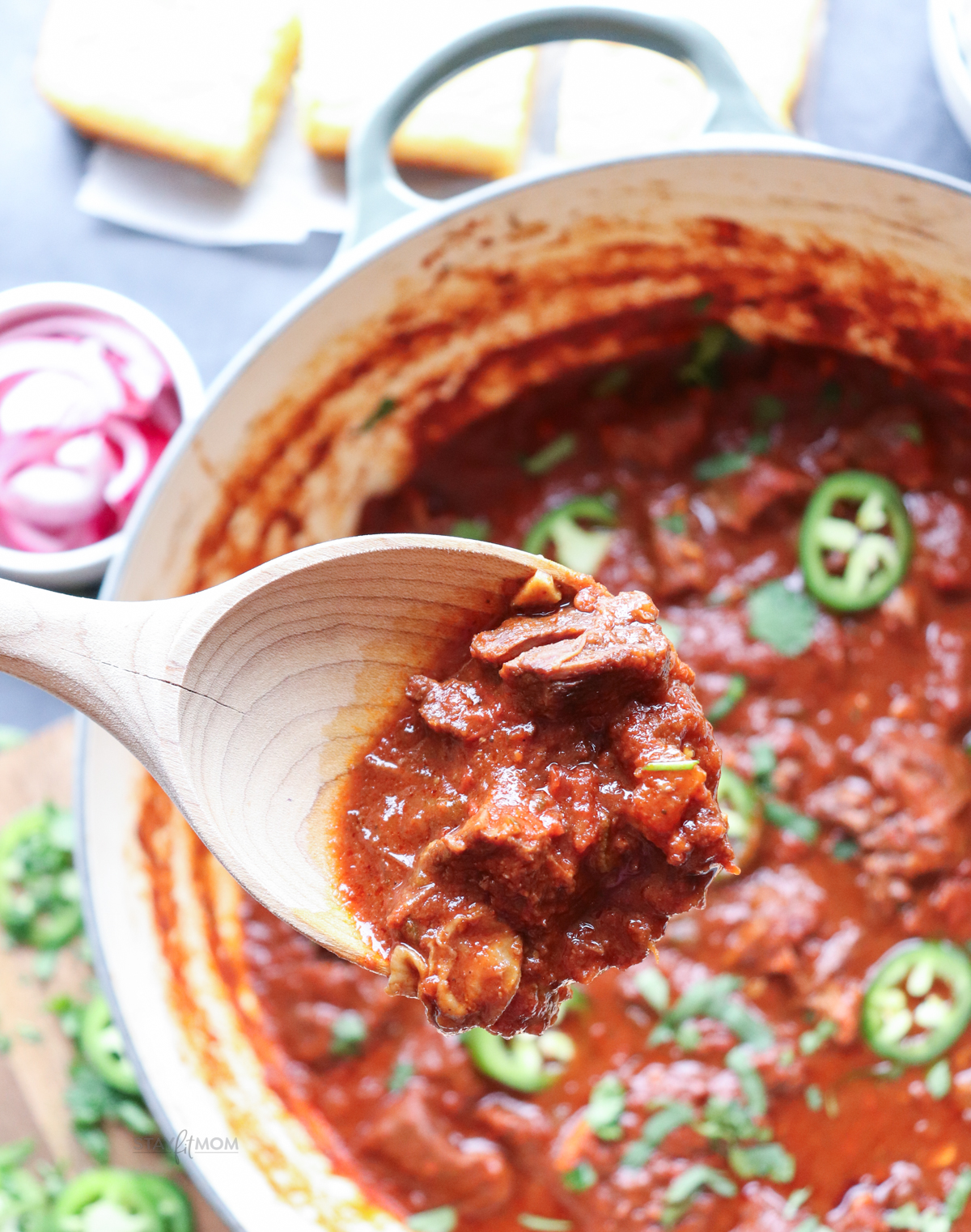 Texas chili showing finished meal with visible sauce, chuck roast, and jalapeno peppers.