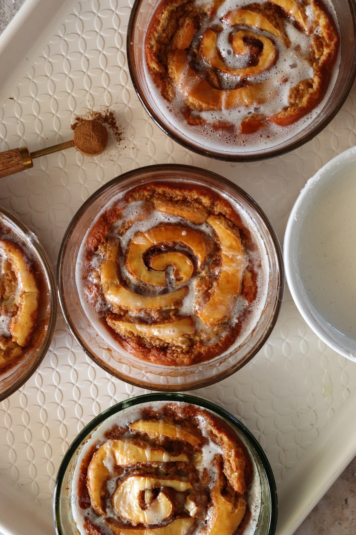 Cinnamon Roll Pancake Bowls showing completed meal topped with a light glaze.