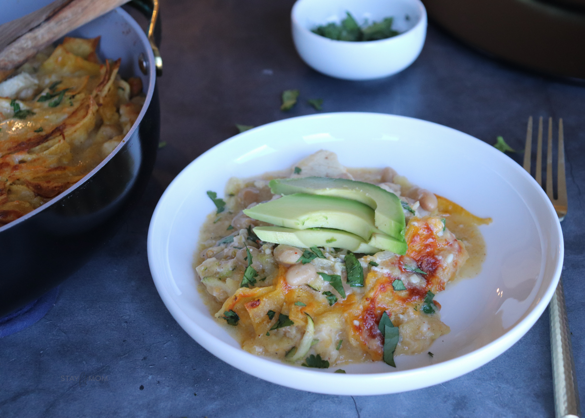White Chicken Enchilada Skillet showing a serving topped with avocado slices.