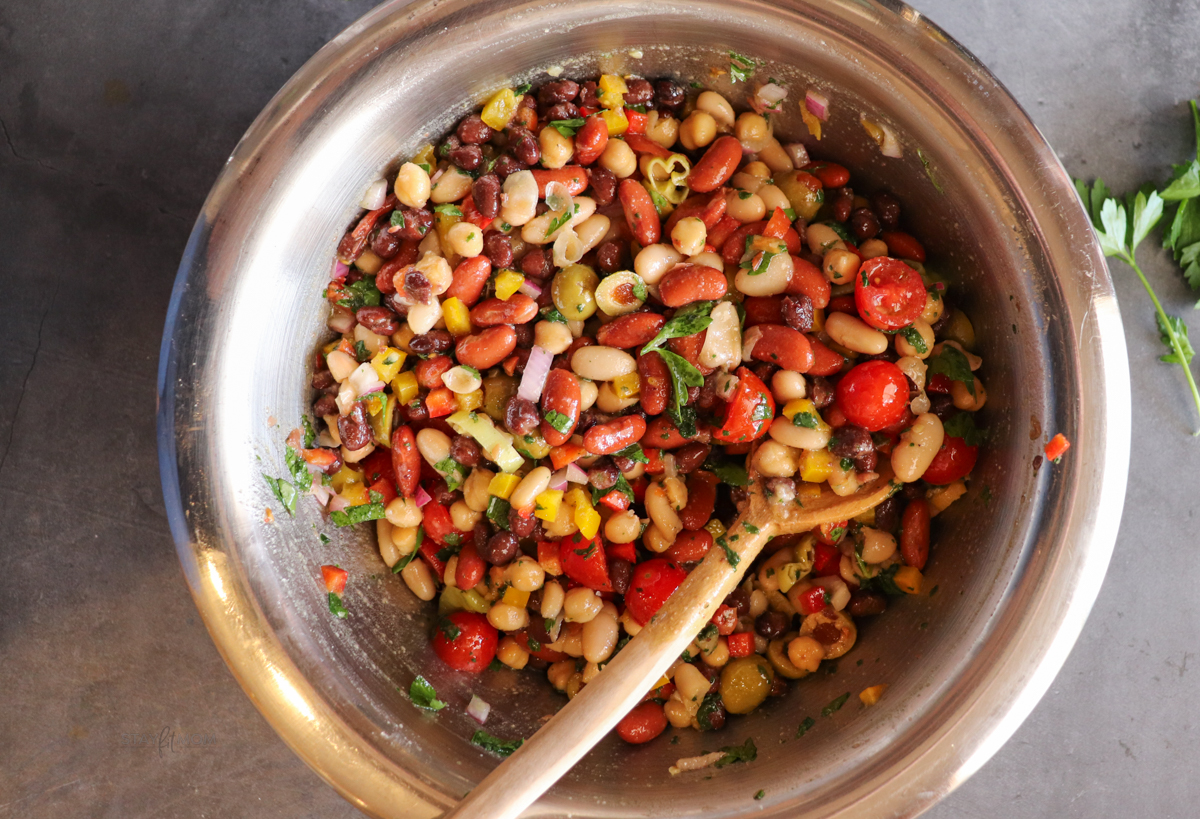 Bean Summer Salad showing completed salad with a spoon ready to serve.