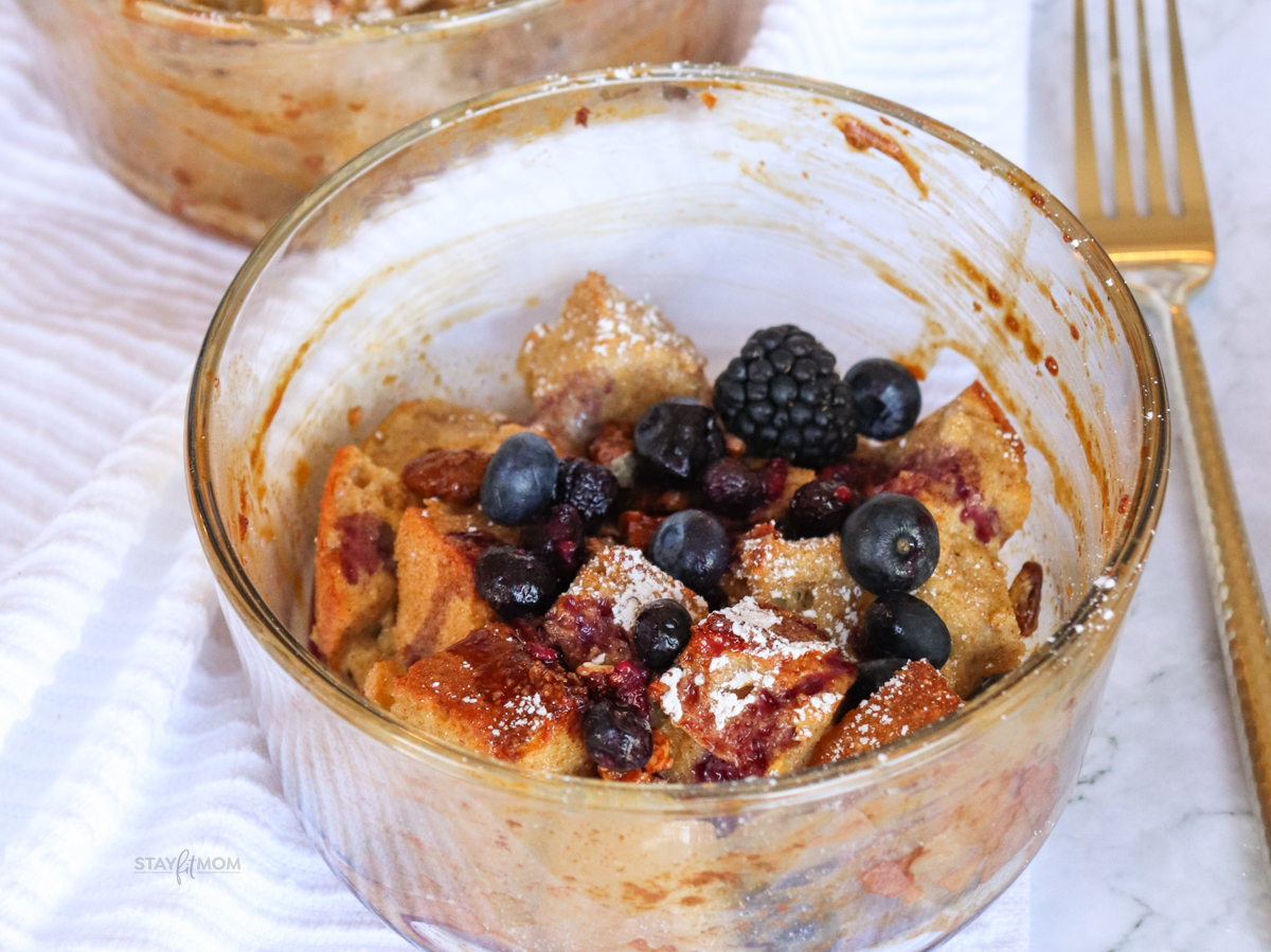 French Toast Bakes showing completed meal with visible bread cubes, berries, and powdered sugar.