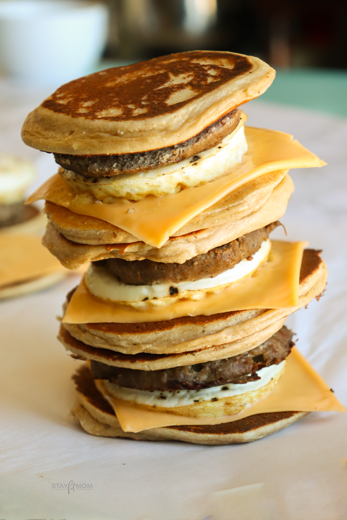 Sausage Griddlers showing a stack of 3 completed sandwiches with visible pancake buns, sausage patties, egg whites, and American cheese.