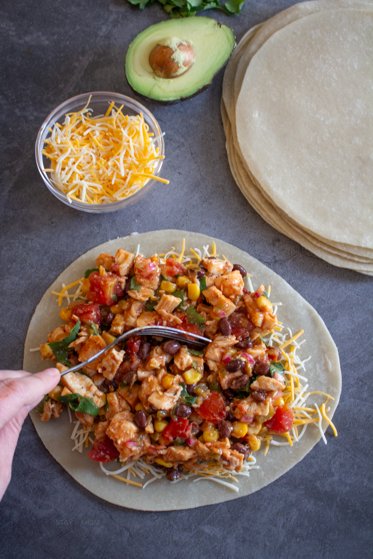 Cowboy Quesadillas showing raw tortilla loaded with cheese and filling, ready to be topped with another tortilla and cooked.