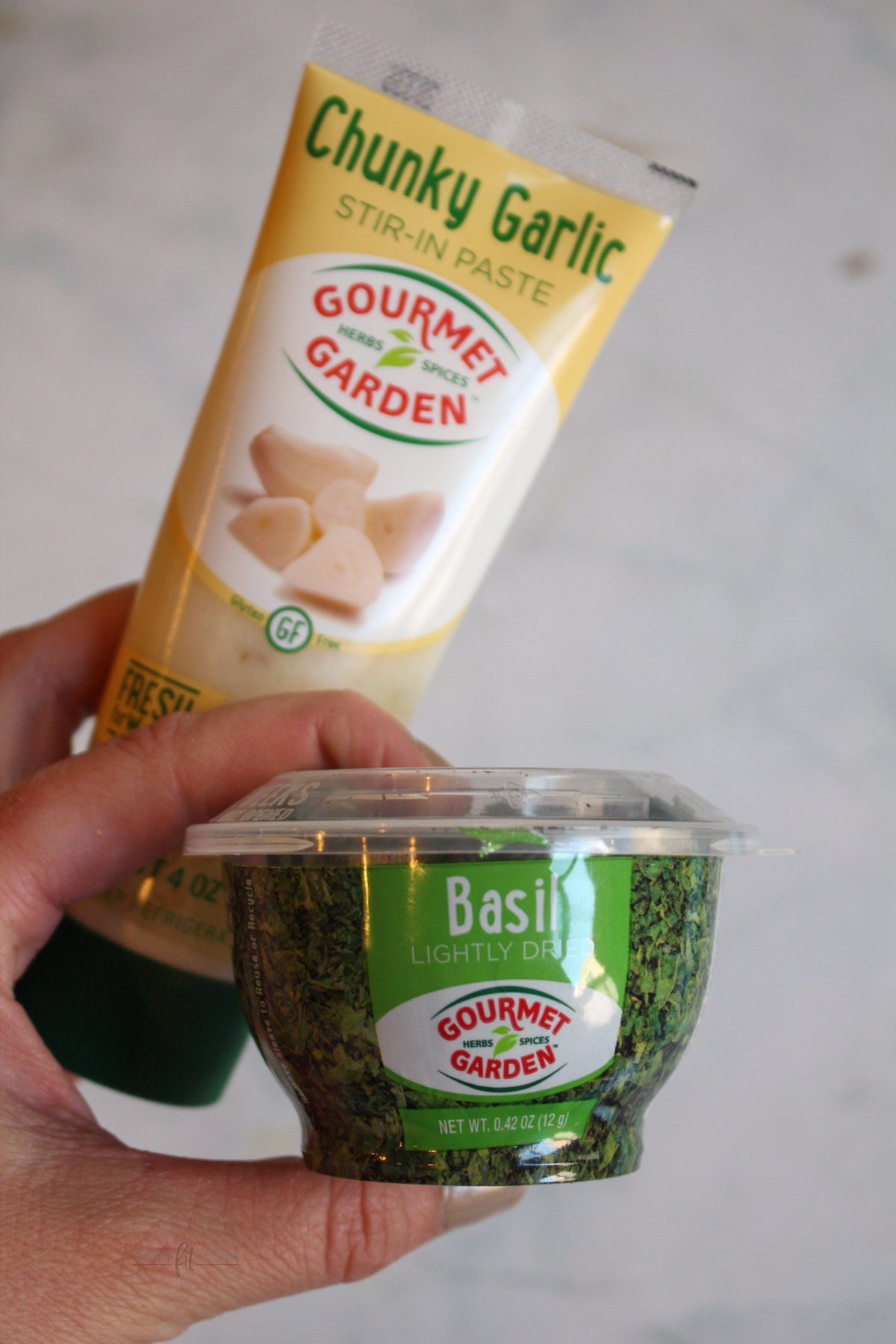 Image of tube of chunky garlic paste and small container of lightly dried basil.