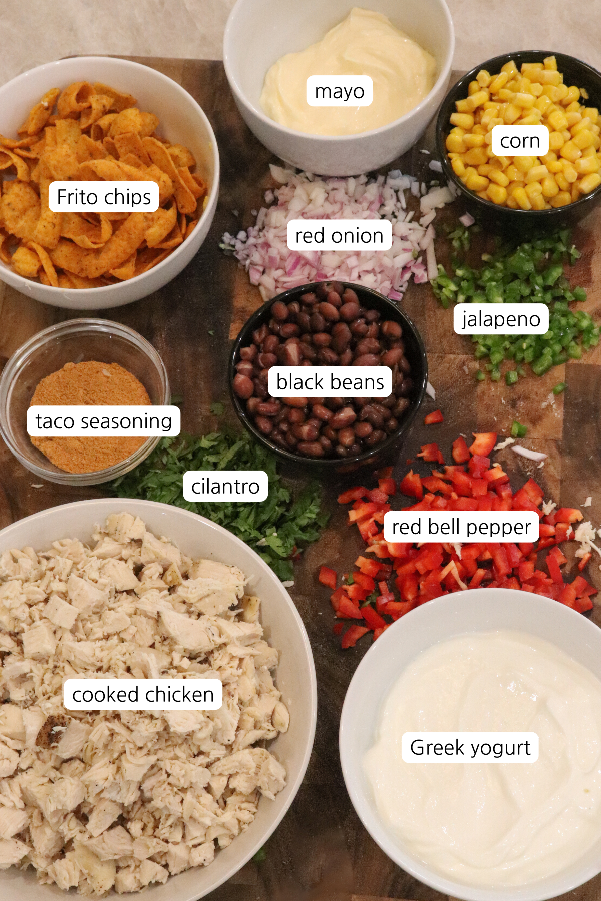 Frito Chicken Salad showing ingredients labeled in small bowls.