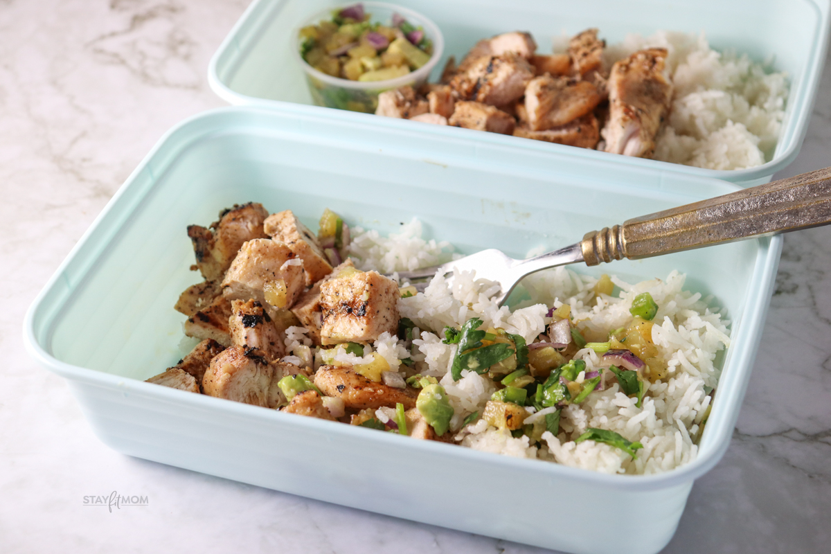 Hawaiian Chicken Bowls showing completed meal with visible cooked rice, chopped grilled chicken, and avocado salsa.