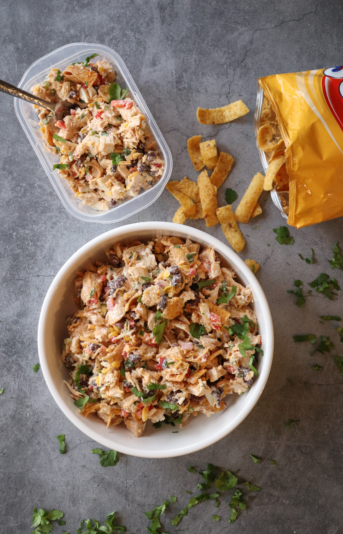 Frito Chicken Salad showing completed recipe in a bowl, a meal prep serving, and some open Fritos.