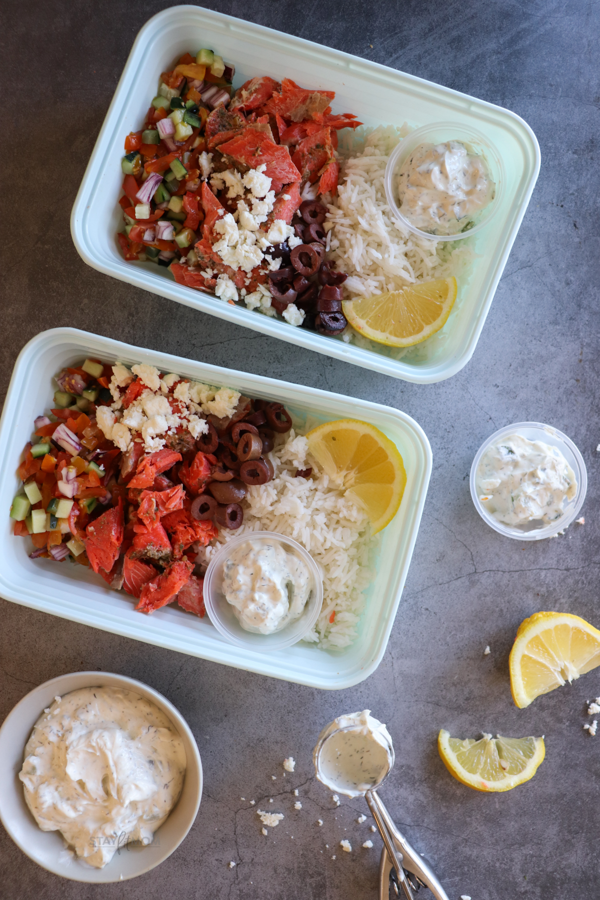 Salmon Greek Bowls showing completed meal prep with visible rice, salmon, olives, tzatziki, and sauce.