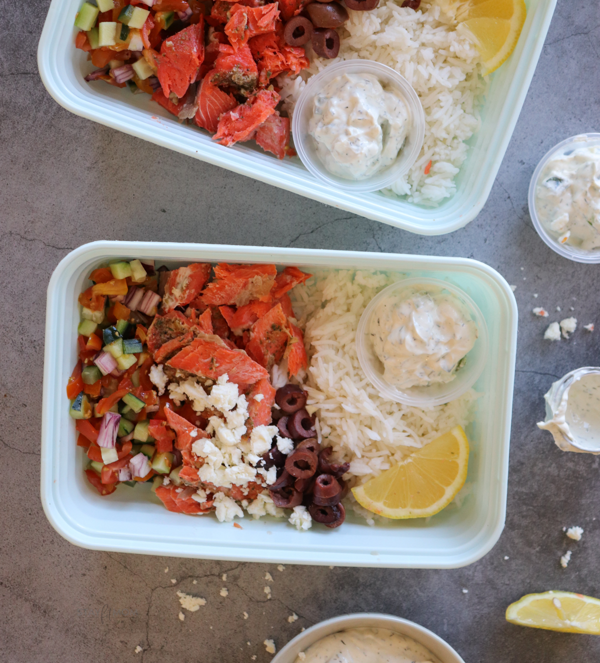Salmon Greek Bowls showing completed meal prep with visible rice, salmon, olives, tzatziki, and sauce.