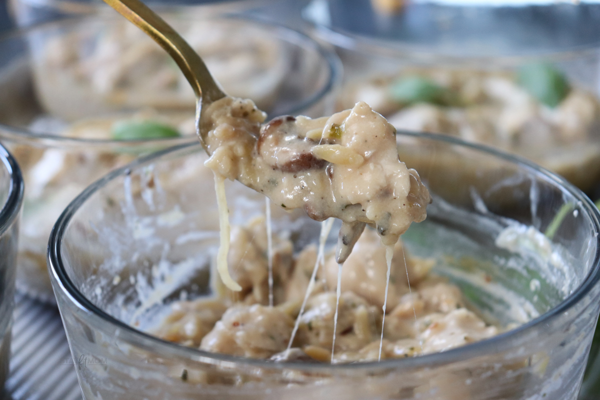 Alfredi Chicken Orzo Bakes showing finished recipe with a bite ready to eat!