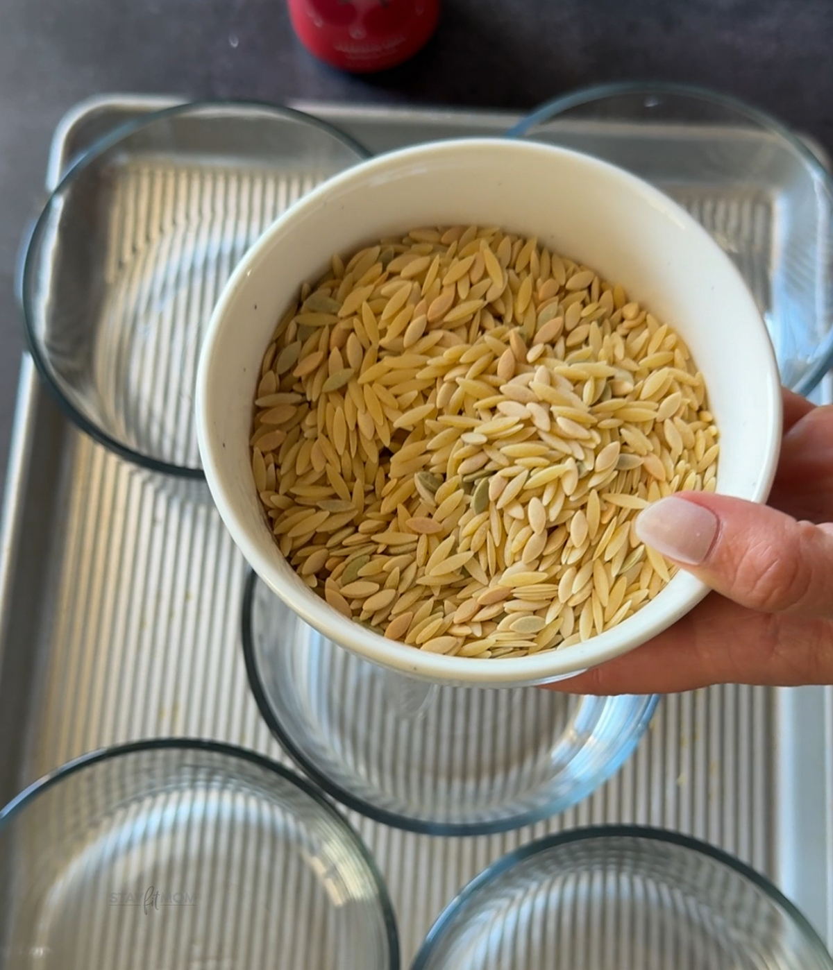 Image of a bowl of uncooked orzo to show what it is.