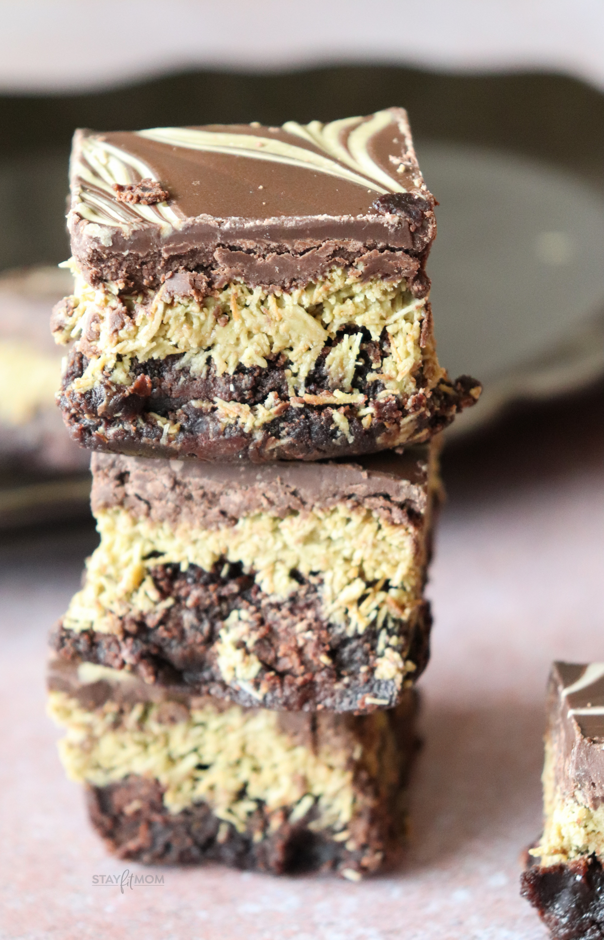 Dubai Chocolate Brownies showing finished brownies with a fudgy bottom, crispy pistachio center, and chocolate top swirled with pistachio cream.