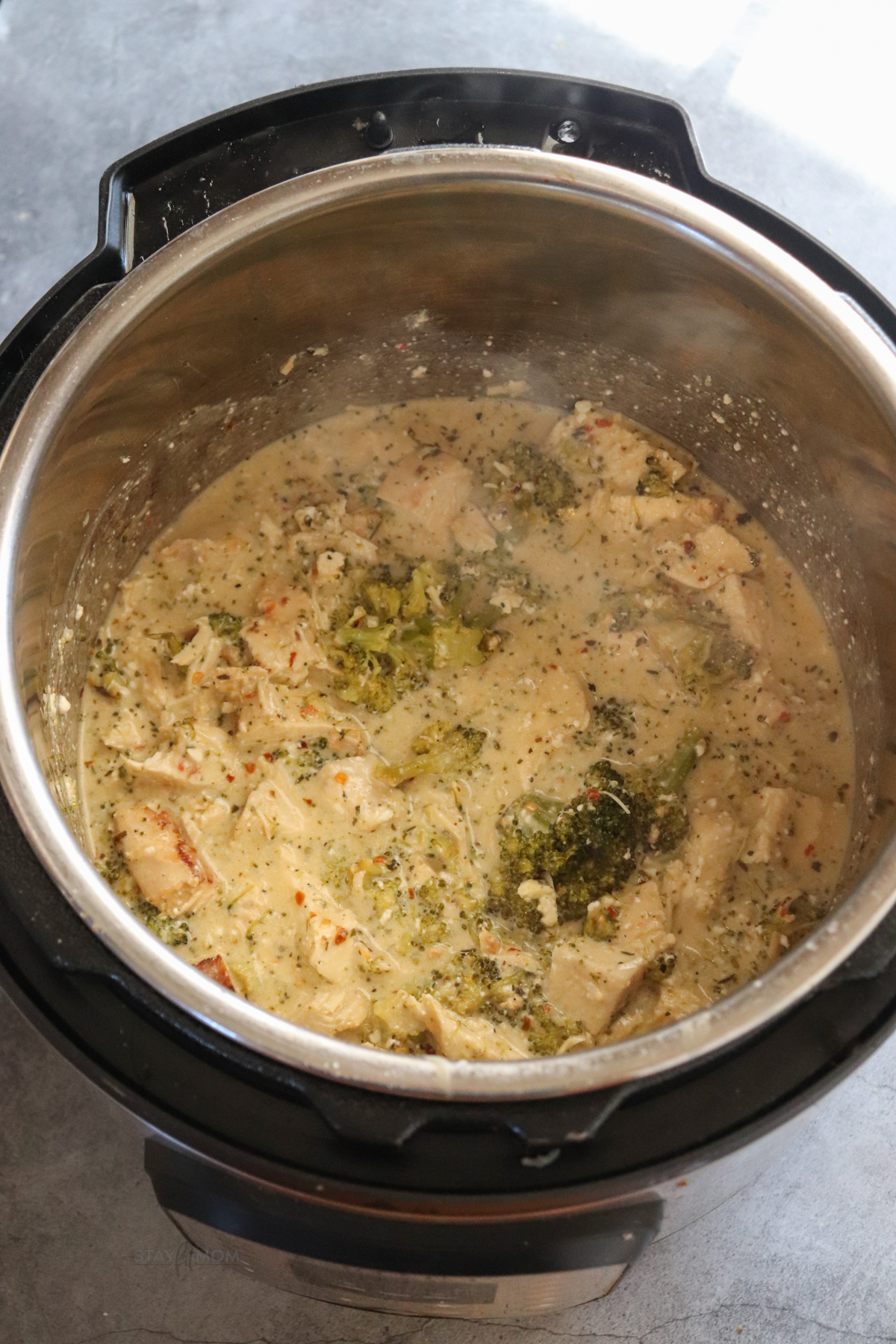 Shredded chicken in creamy garlic parmesan sauce inside the pot before adding pasta.