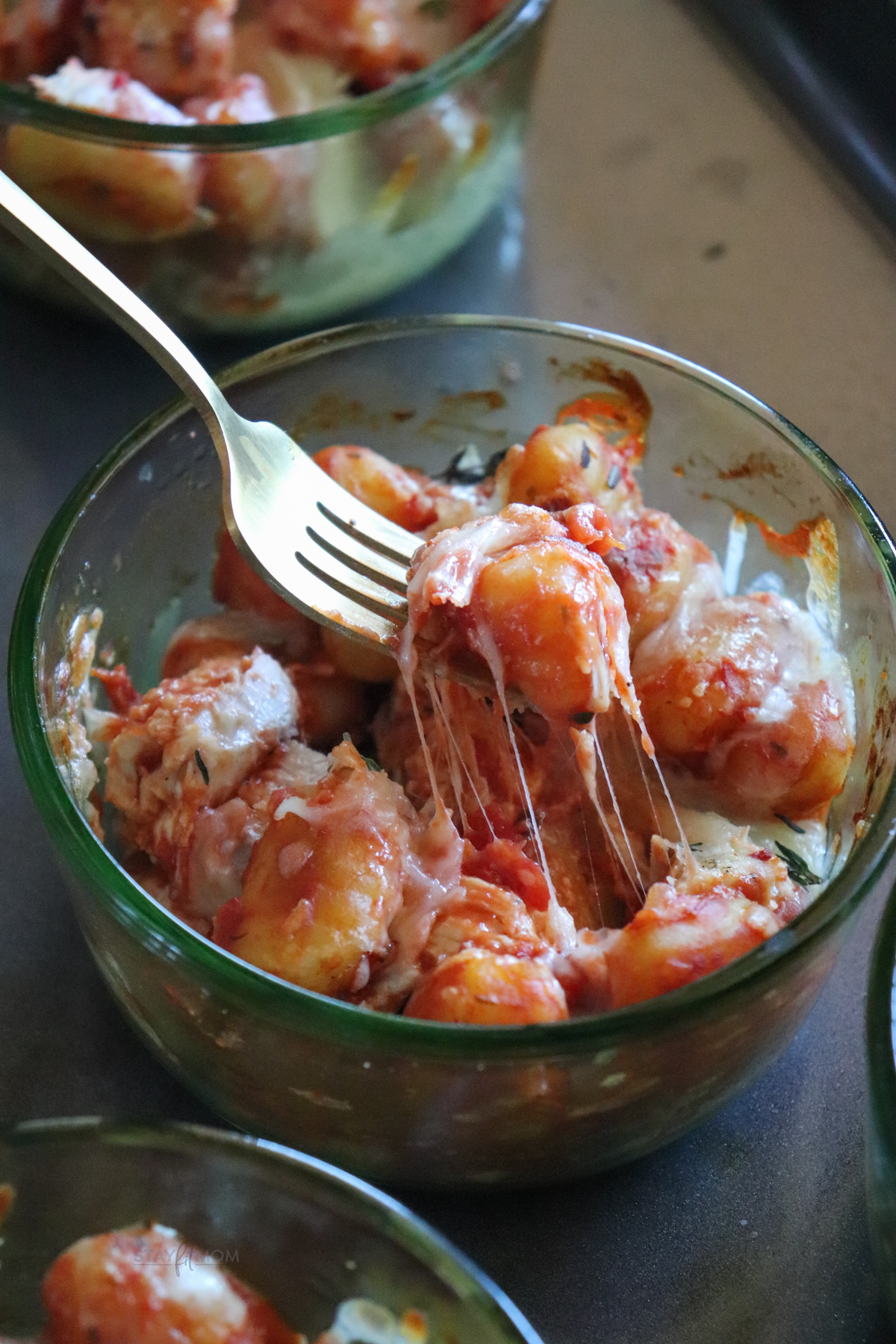 Close-up of a single Chicken Parmesan Gnocchi Bowl with melted cheese and marinara sauce for a comforting, macro-friendly meal.