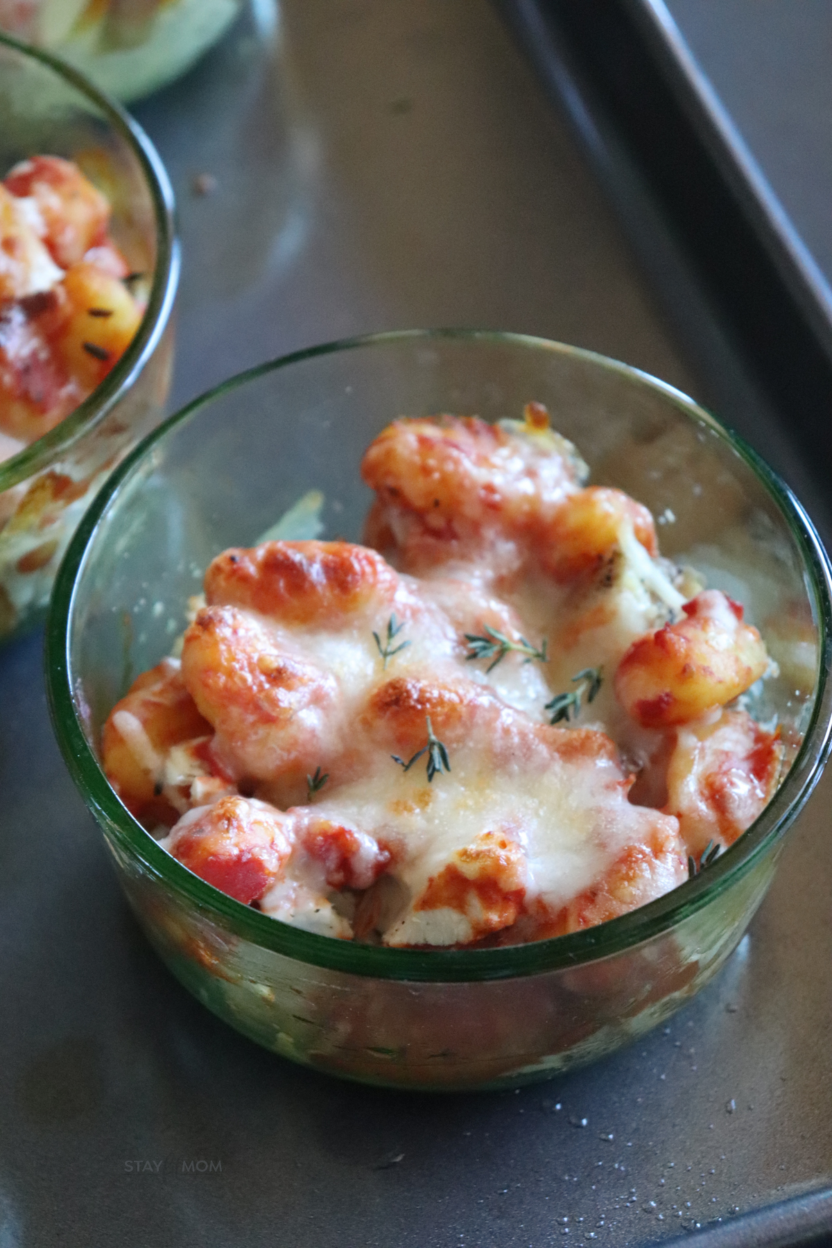 Close-up of a single Chicken Parmesan Gnocchi Bowl with melted cheese and marinara sauce for a comforting, macro-friendly meal.