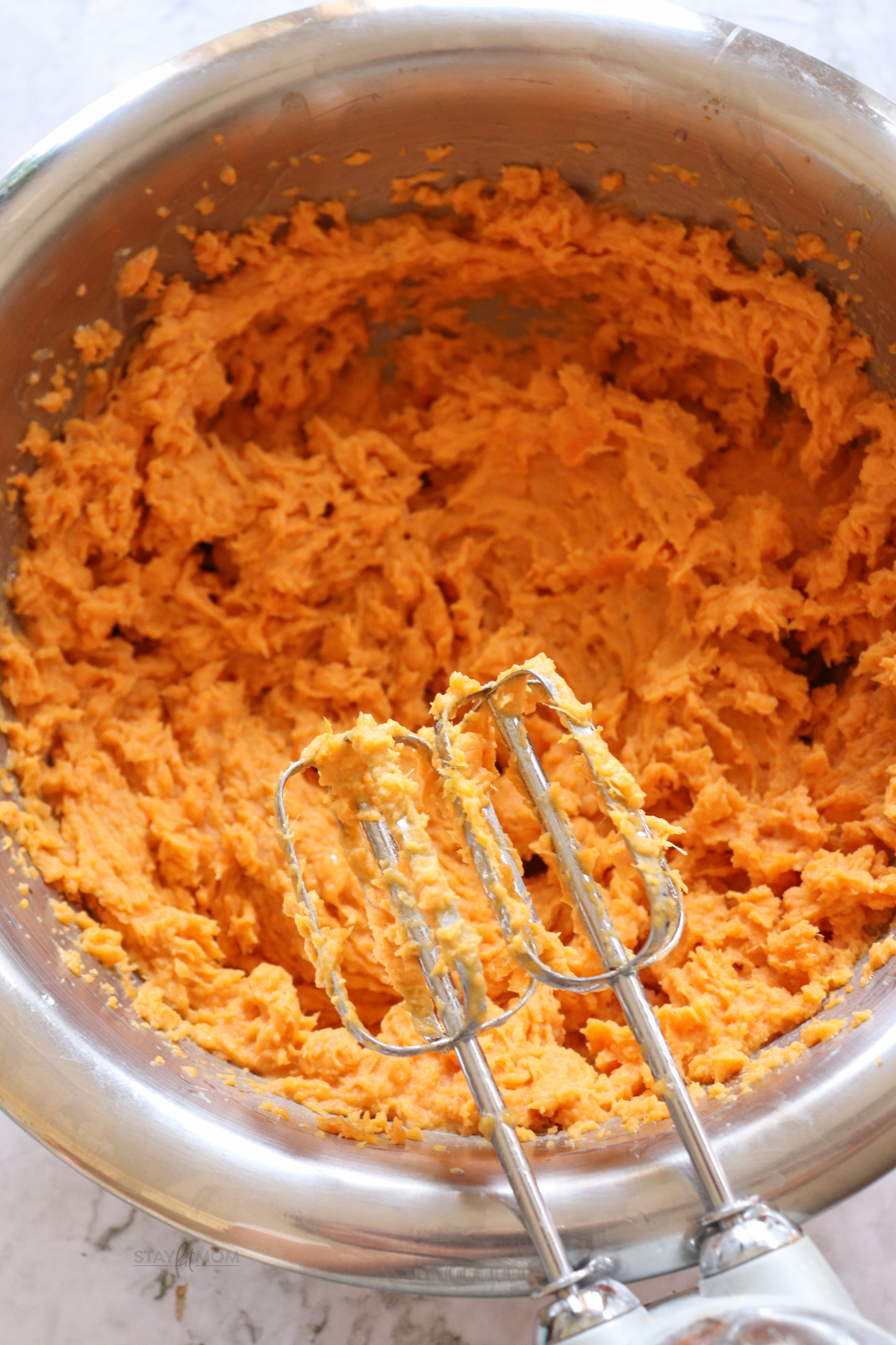 Sweet potato casserole showing bowl with whipped sweet potatoes.