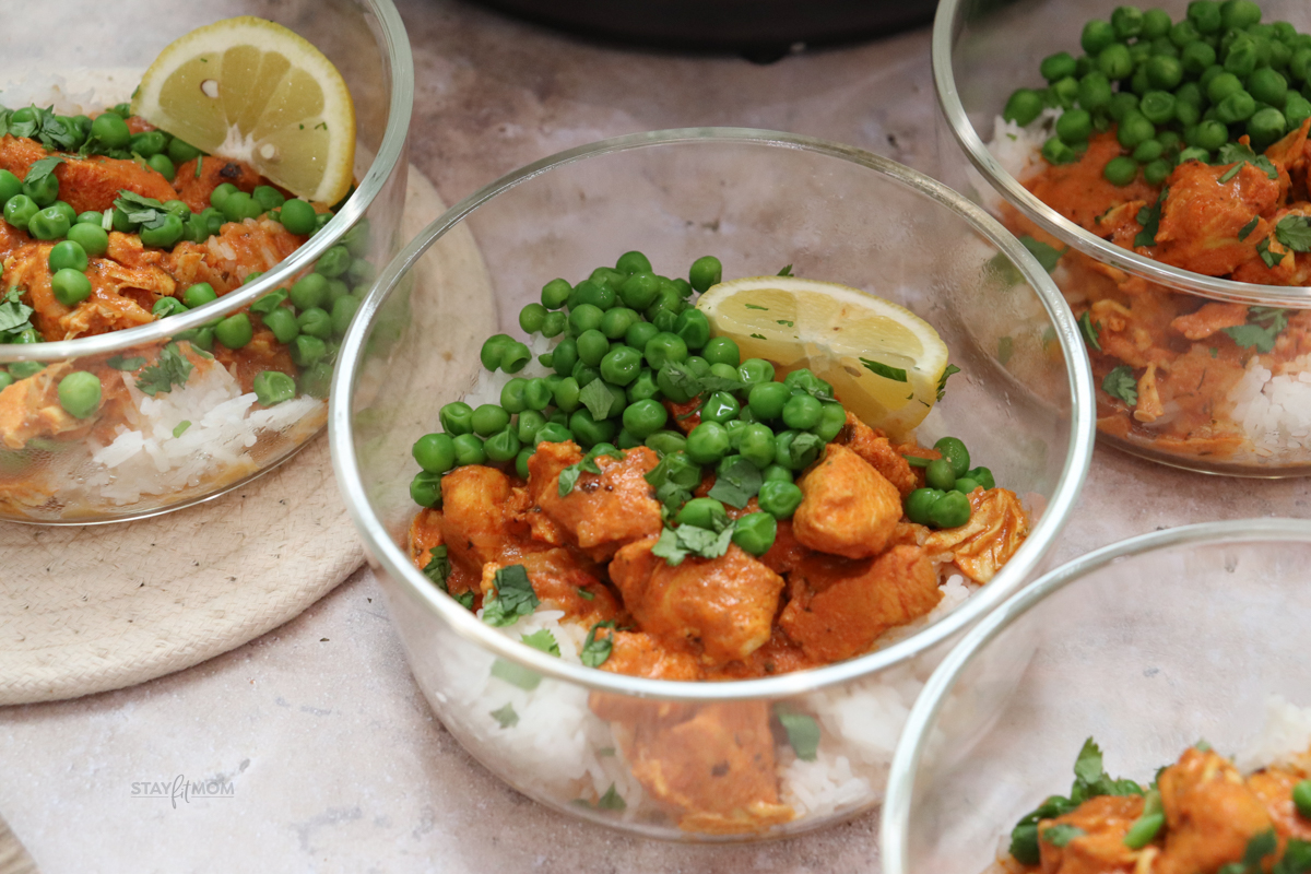 “Six glass meal prep bowls filled with chicken tikka masala, ready for the fridge. High-protein, macro-balanced lunches for the week.”