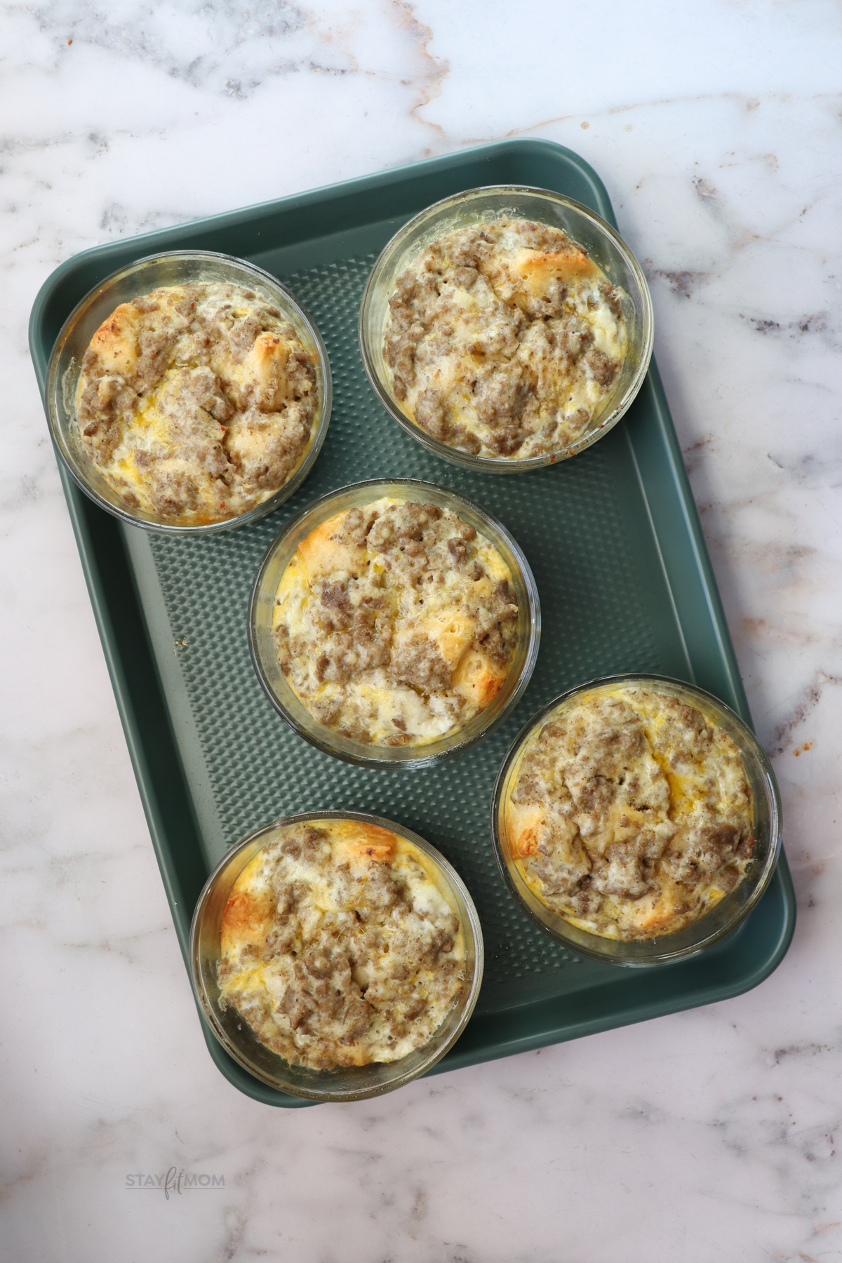 Meal prepped biscuit and gravy breakfast bowls ready for the week in oven-safe containers.