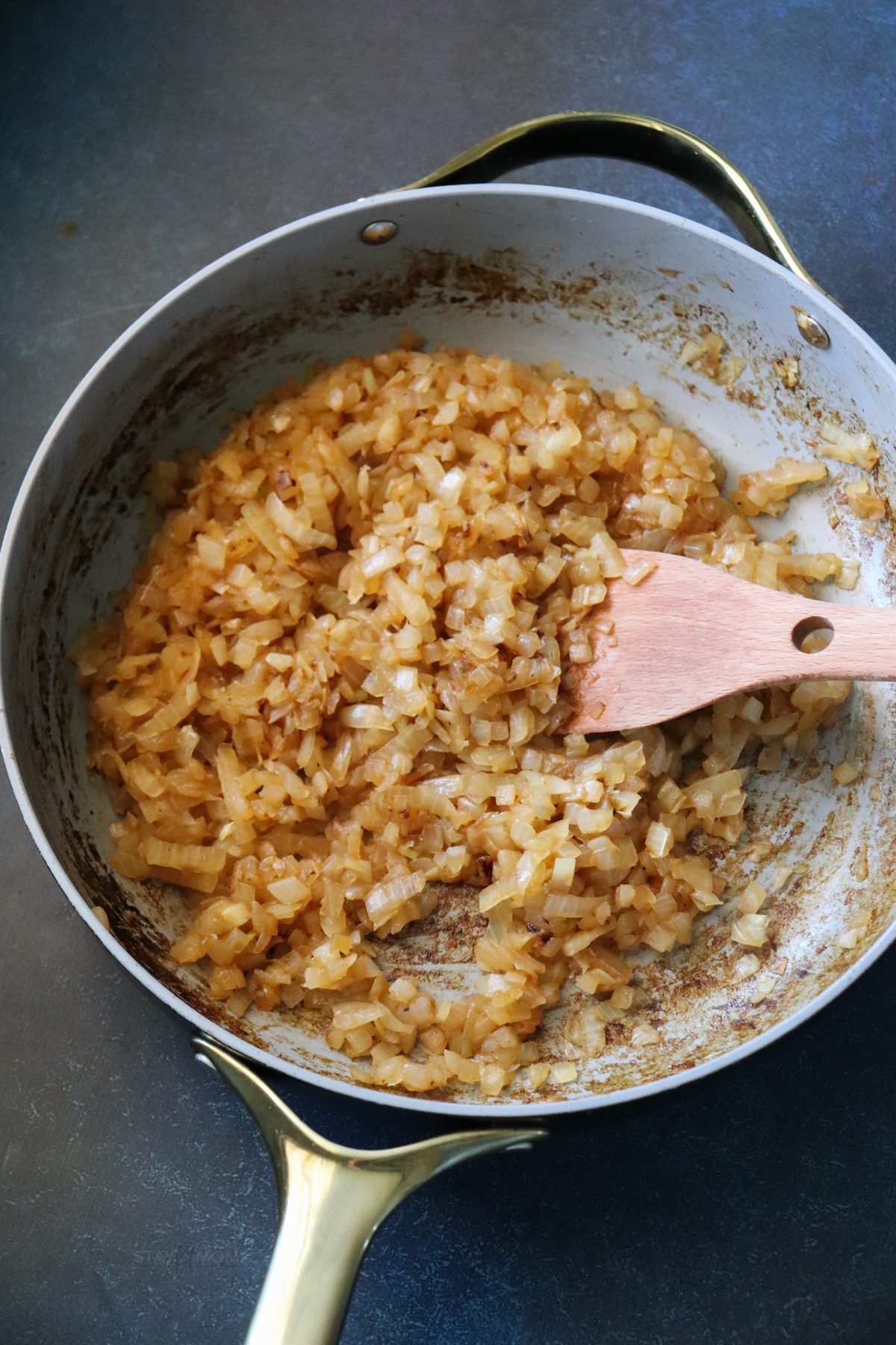 A saucepan showing diced, caramelized onions.