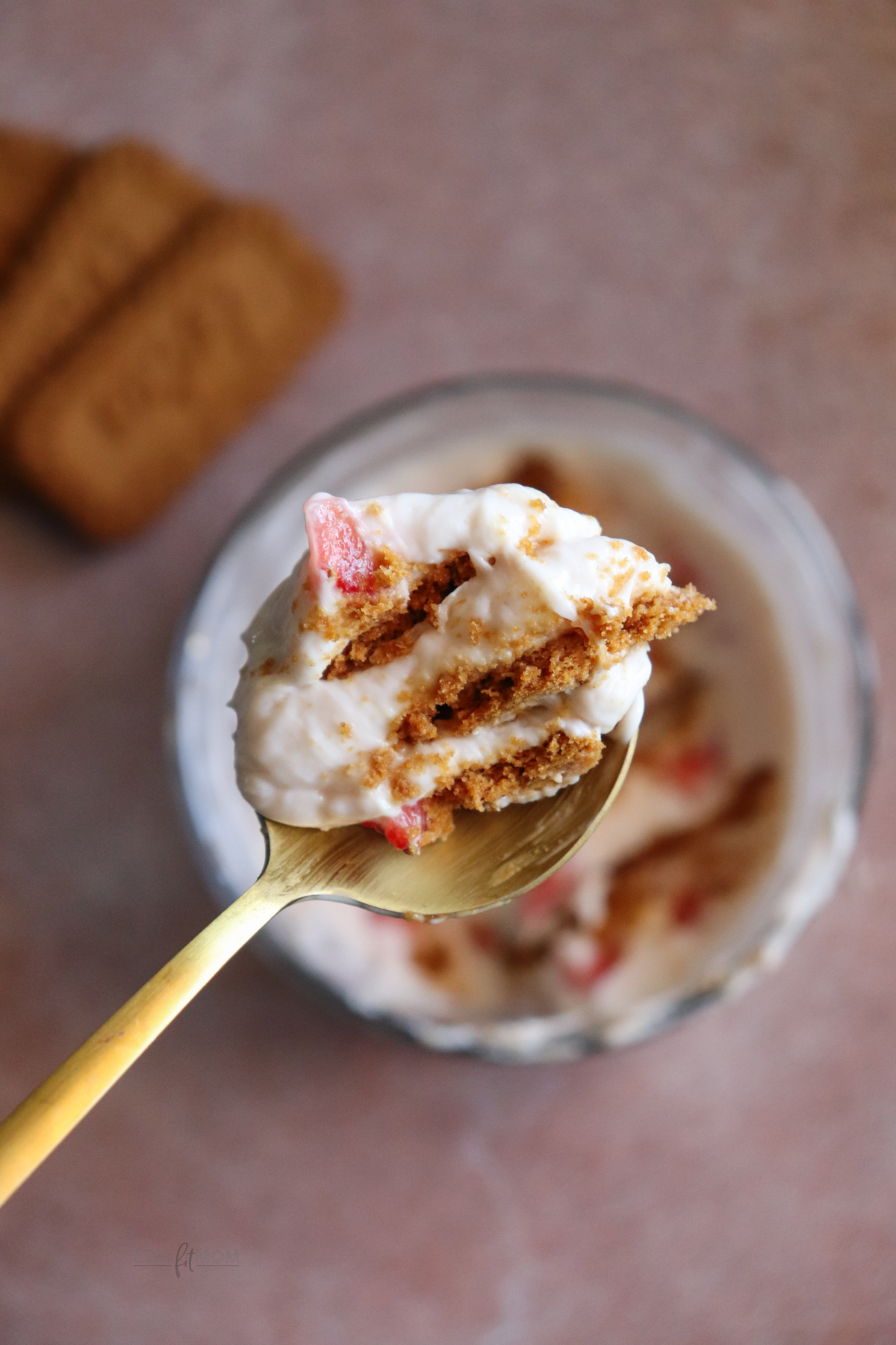 Protein Cheesecake for showing a close-up, perfect bit of greek yogurt, strawberries, and biscoff cookies.